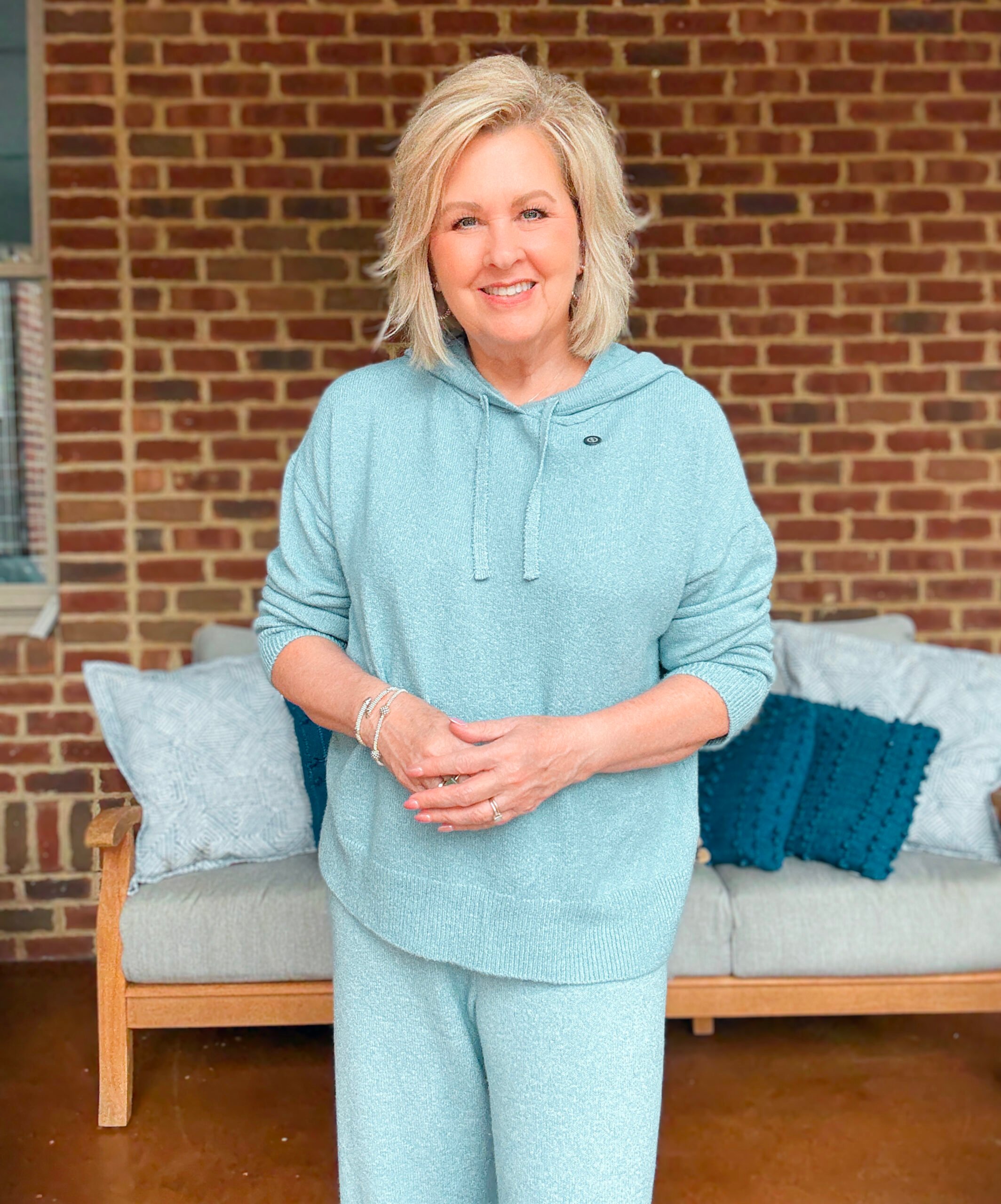 Tania wearing alight blue hoodie sweater 