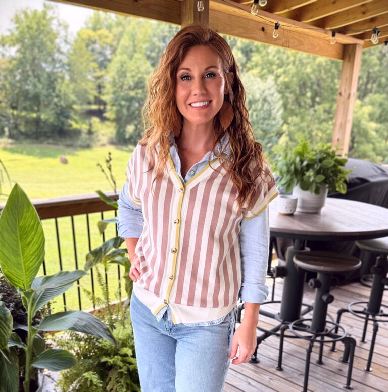 Stephanie wearing a striped vest from Amazon with a blue shirt and light wash jeans