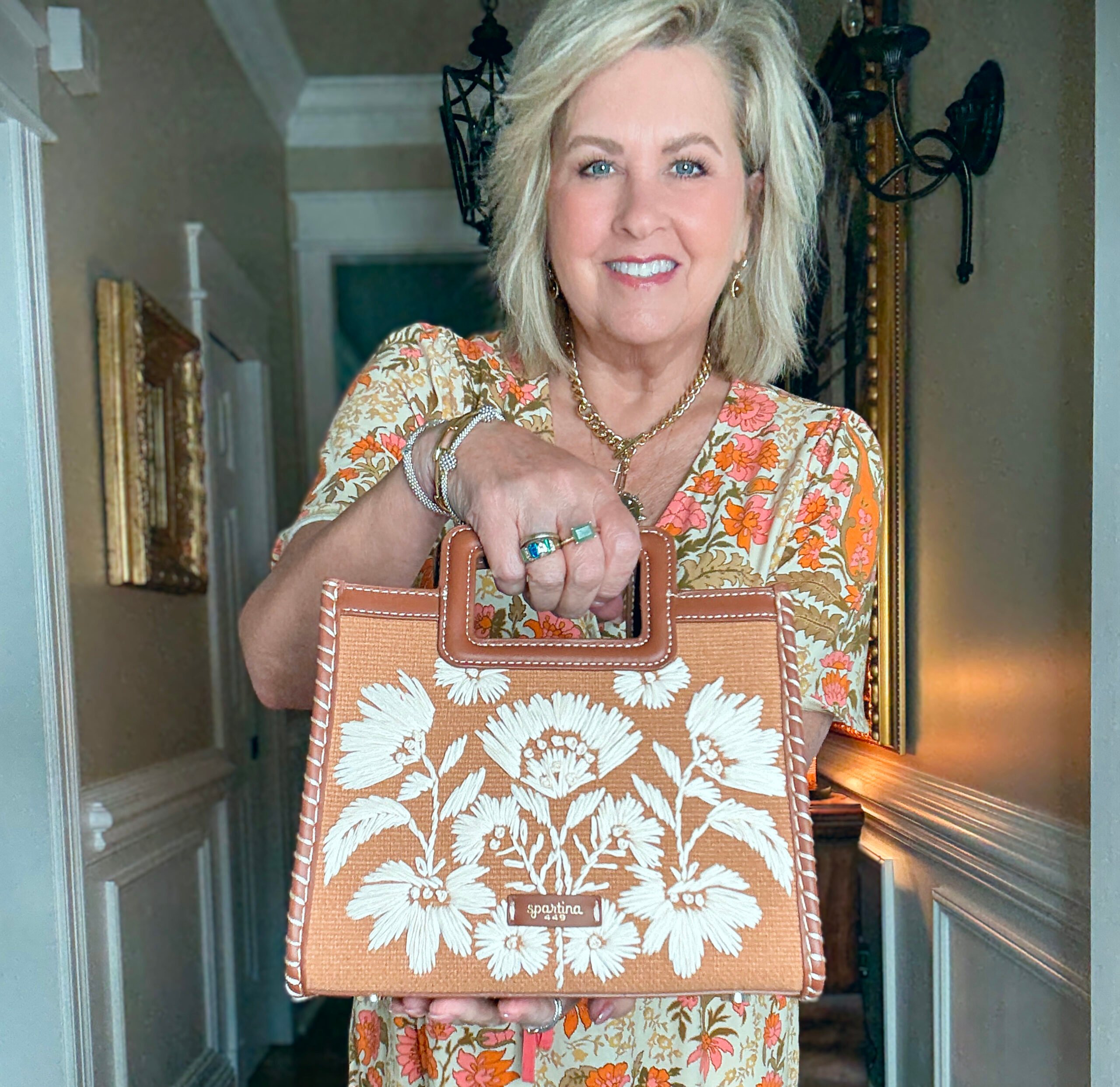 Tania Stephens wearing a beautiful floral maxi dress with a floral handbag
