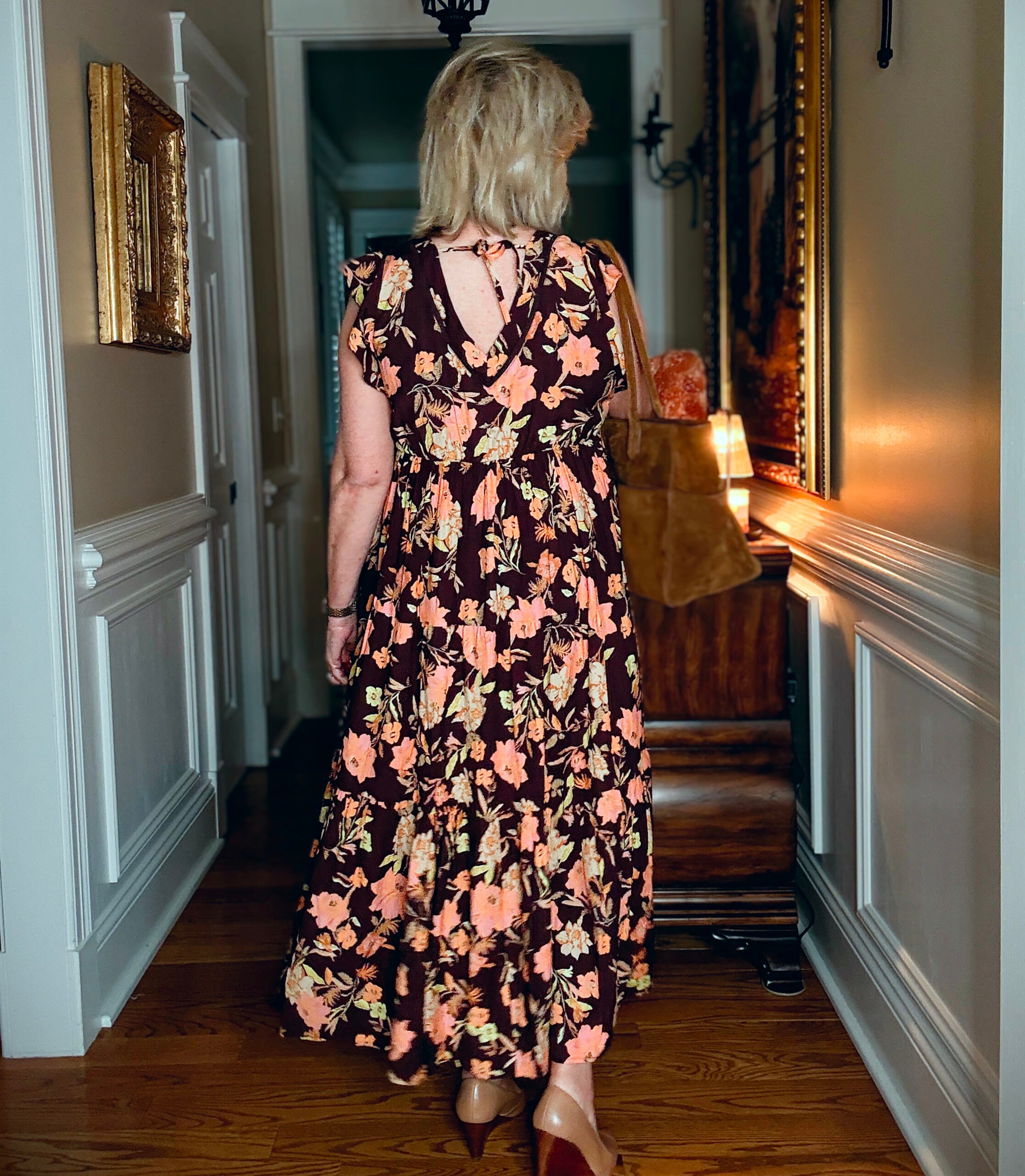 Tania showing the back of  a V-Neck floral maxi dress from Nordstrom