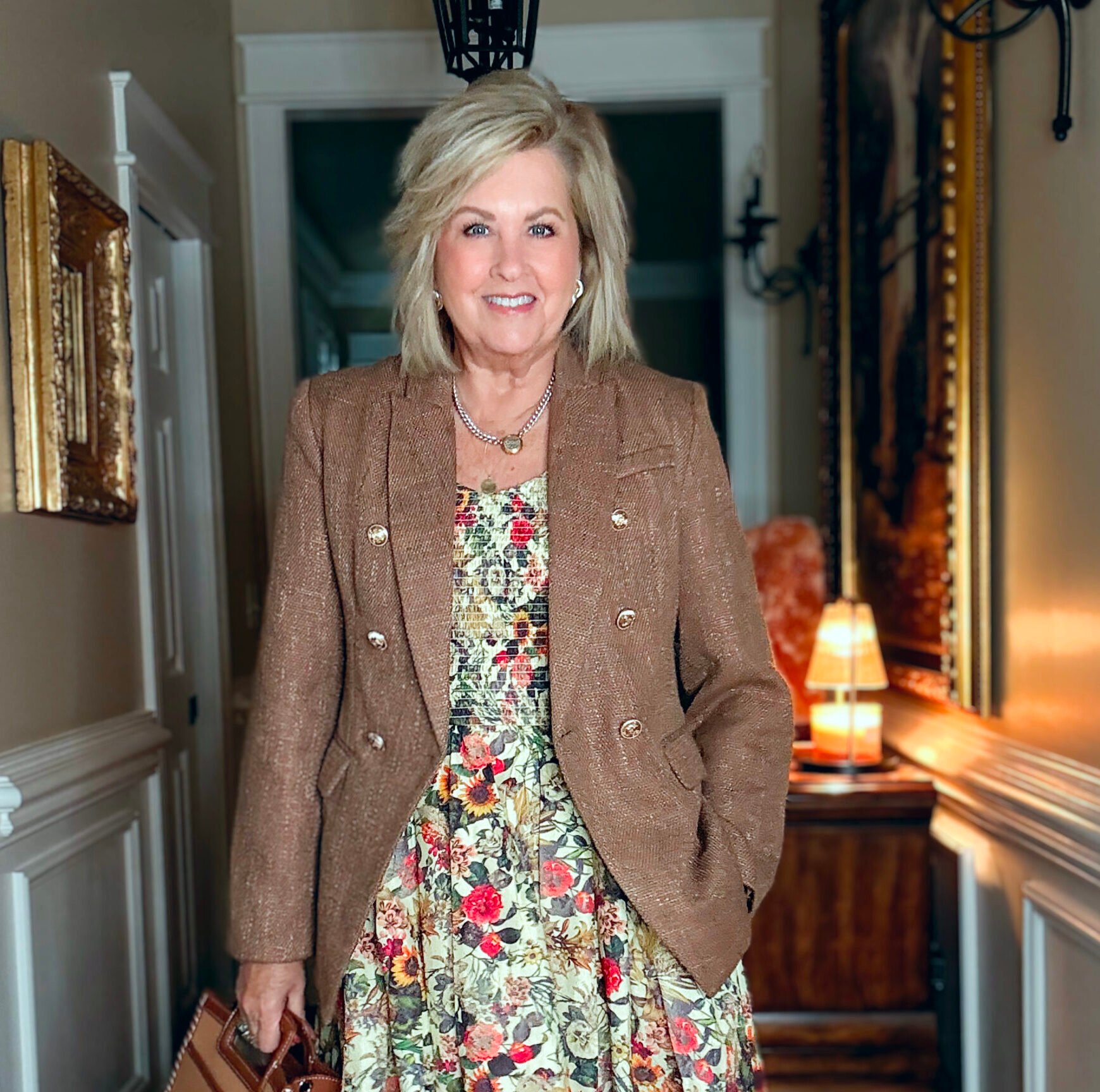 Tania wearing a V-Neck floral midi dress with a brown tweed blazer