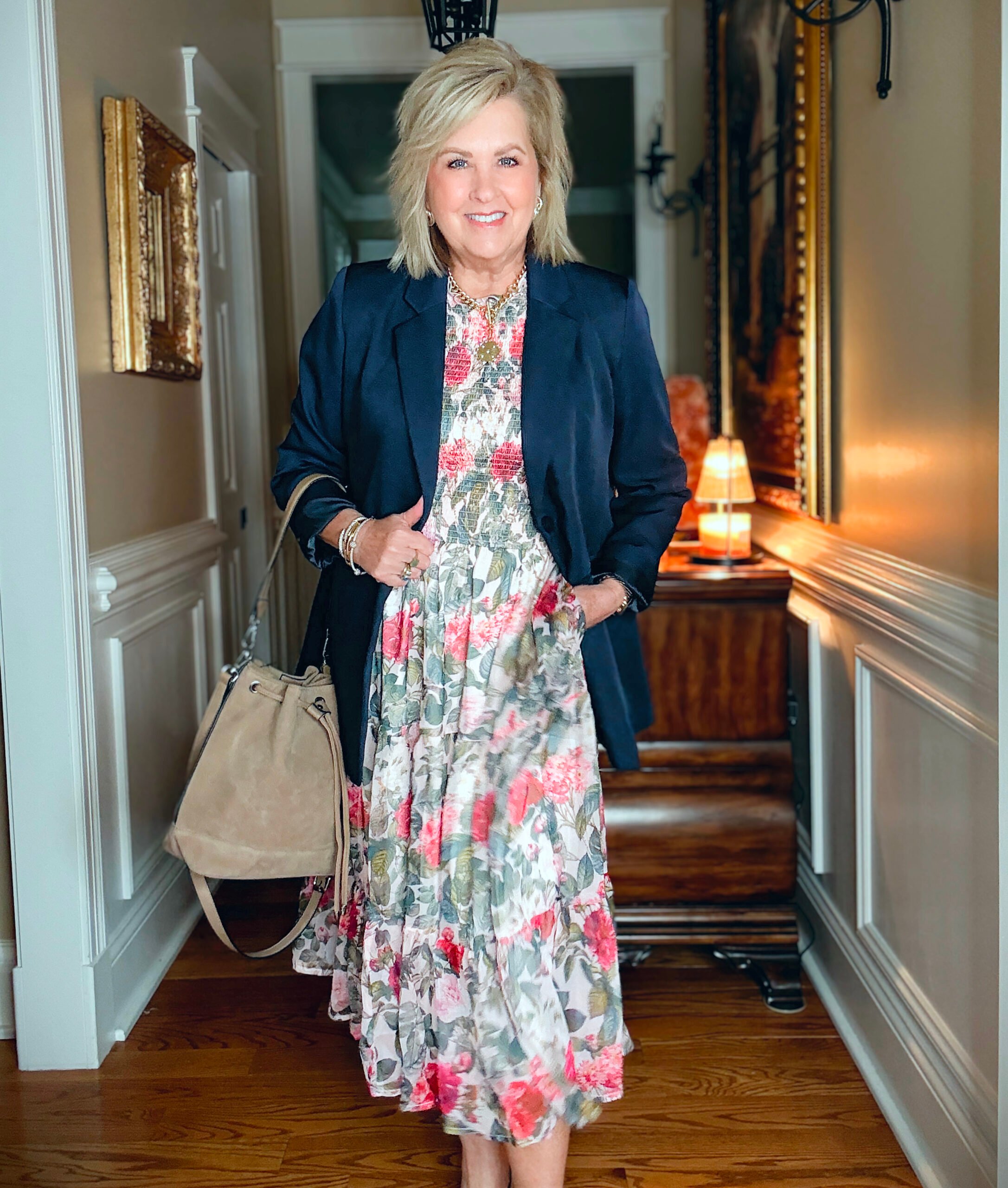 Tania wearing a crewneck floral midi dress from Ivy City with a long navy blazer