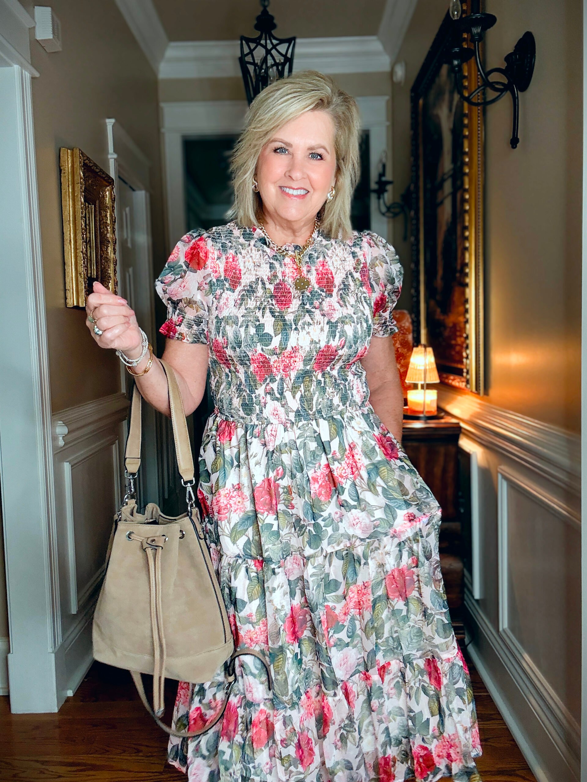 Tania showing a close up of a crewneck floral midi dress from Ivy City