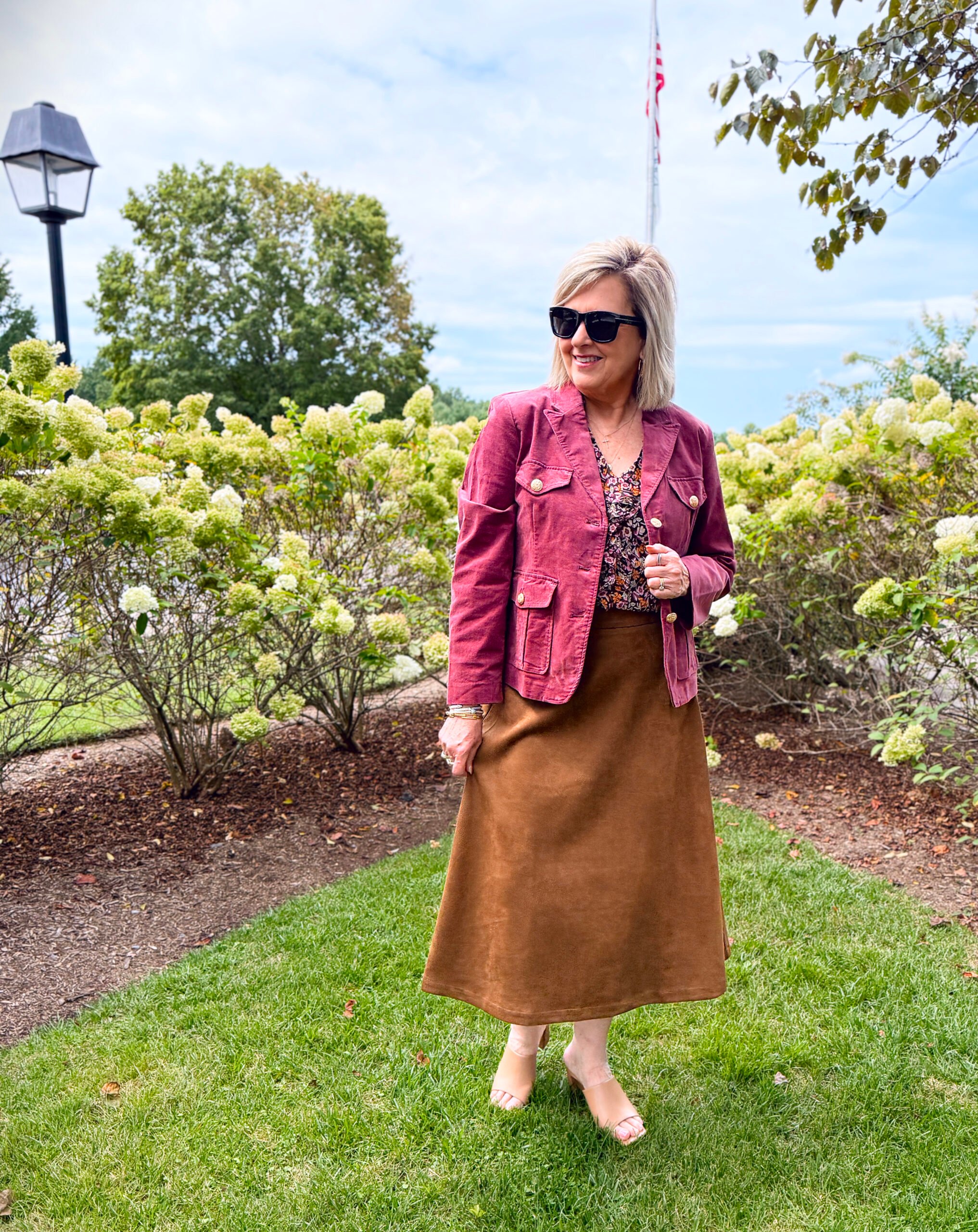 Tania Stephens wearing a printed ruffled top with a corduroy jacket and a faux suede skirt for fall from Kohl's