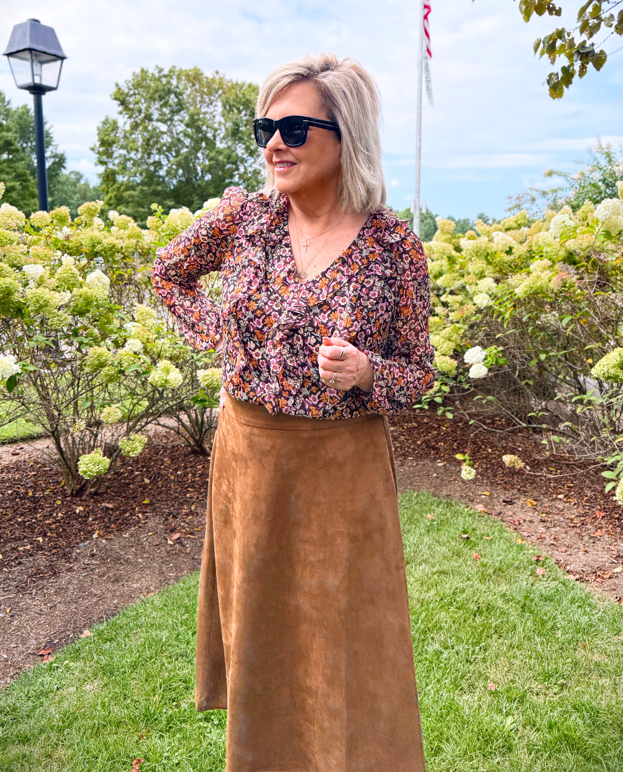 Tania Stephens wearing a printed ruffled top with a faux suede skirt for fall from Kohl's