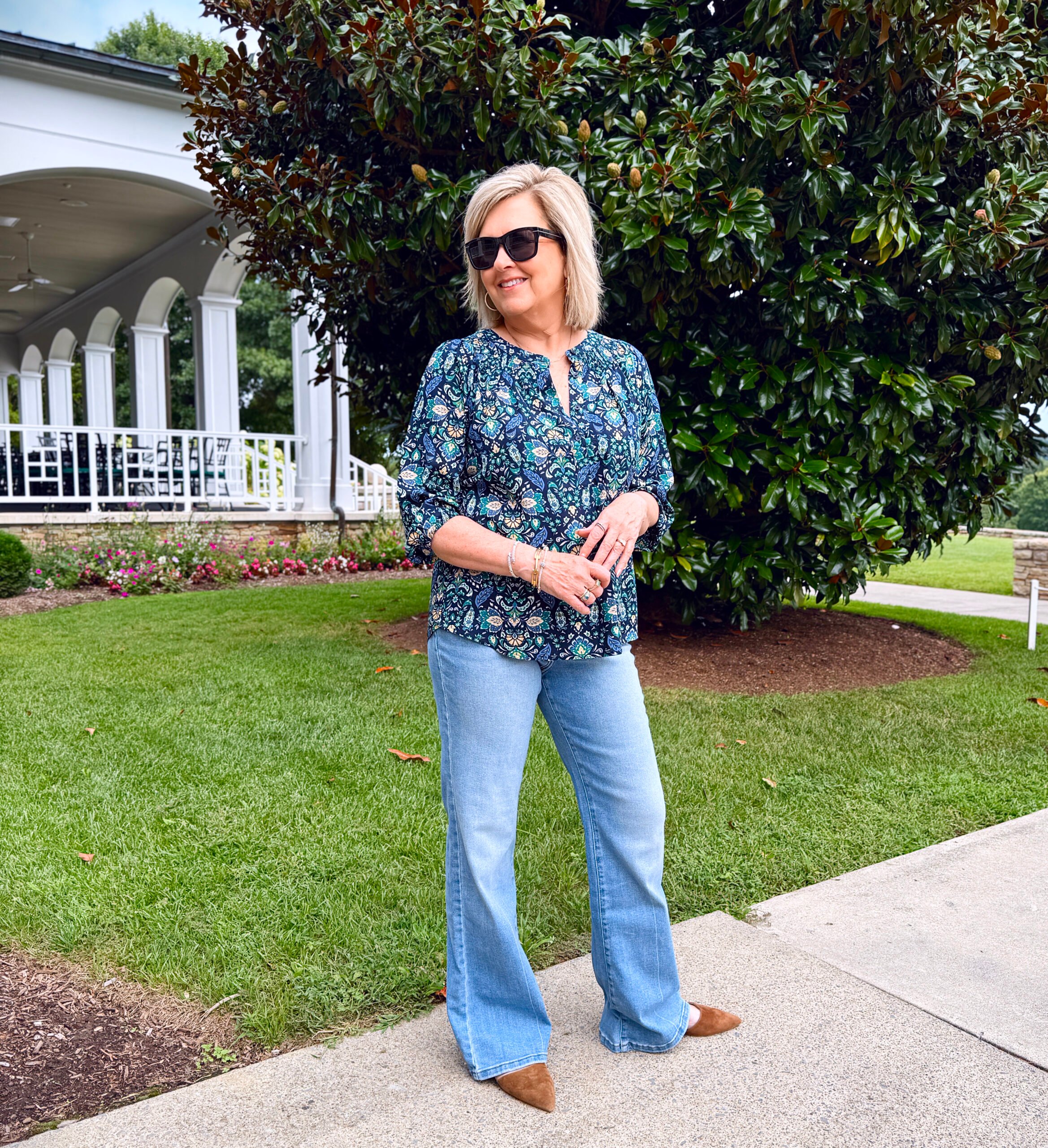 Tania Stephens wearing a blue pullover top with wide leg jeans for fall from Kohl's
