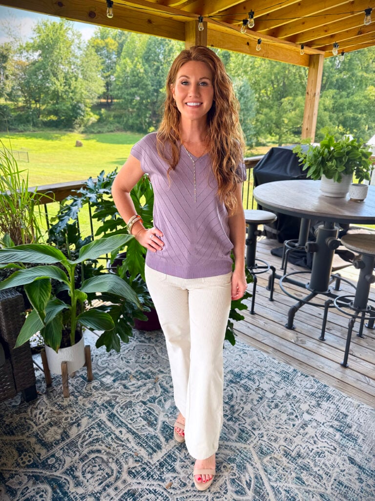 Stephanie wearing a purple sweater from Amazon with cream corduroy pants