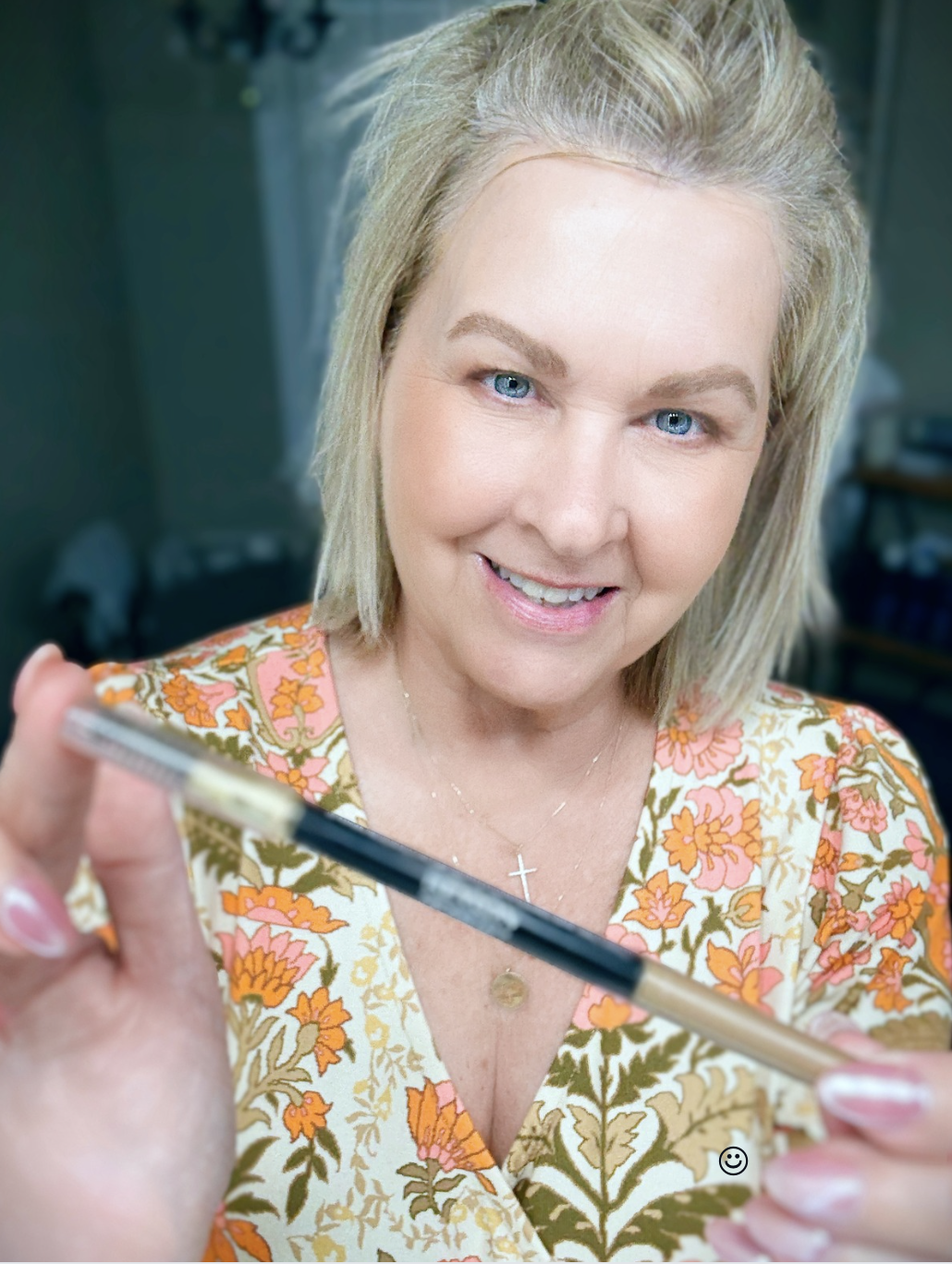 Tania showing the eyebrow pencil from Revlon