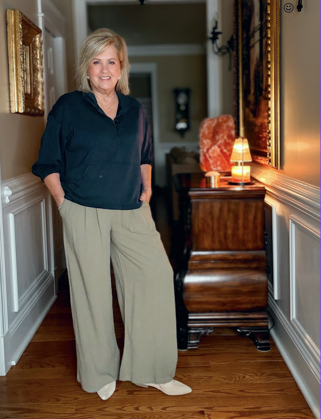 Tania wearing navy cropped zip top and pull on olive pants