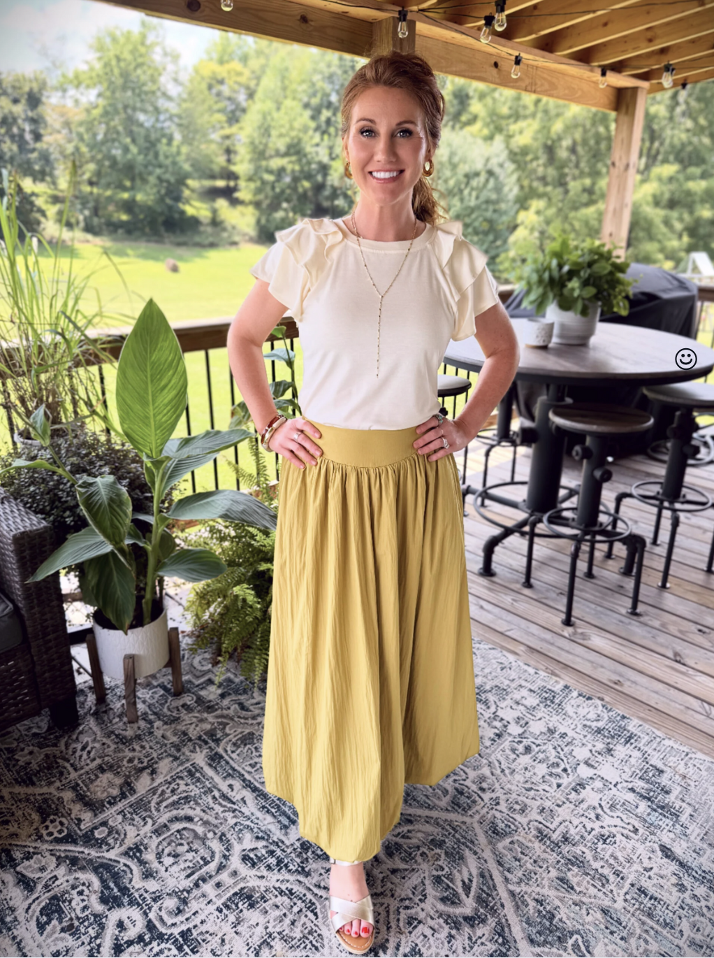 Stephanie wearing a chartreuse bubble skirt from Amazon with a light ruffle top