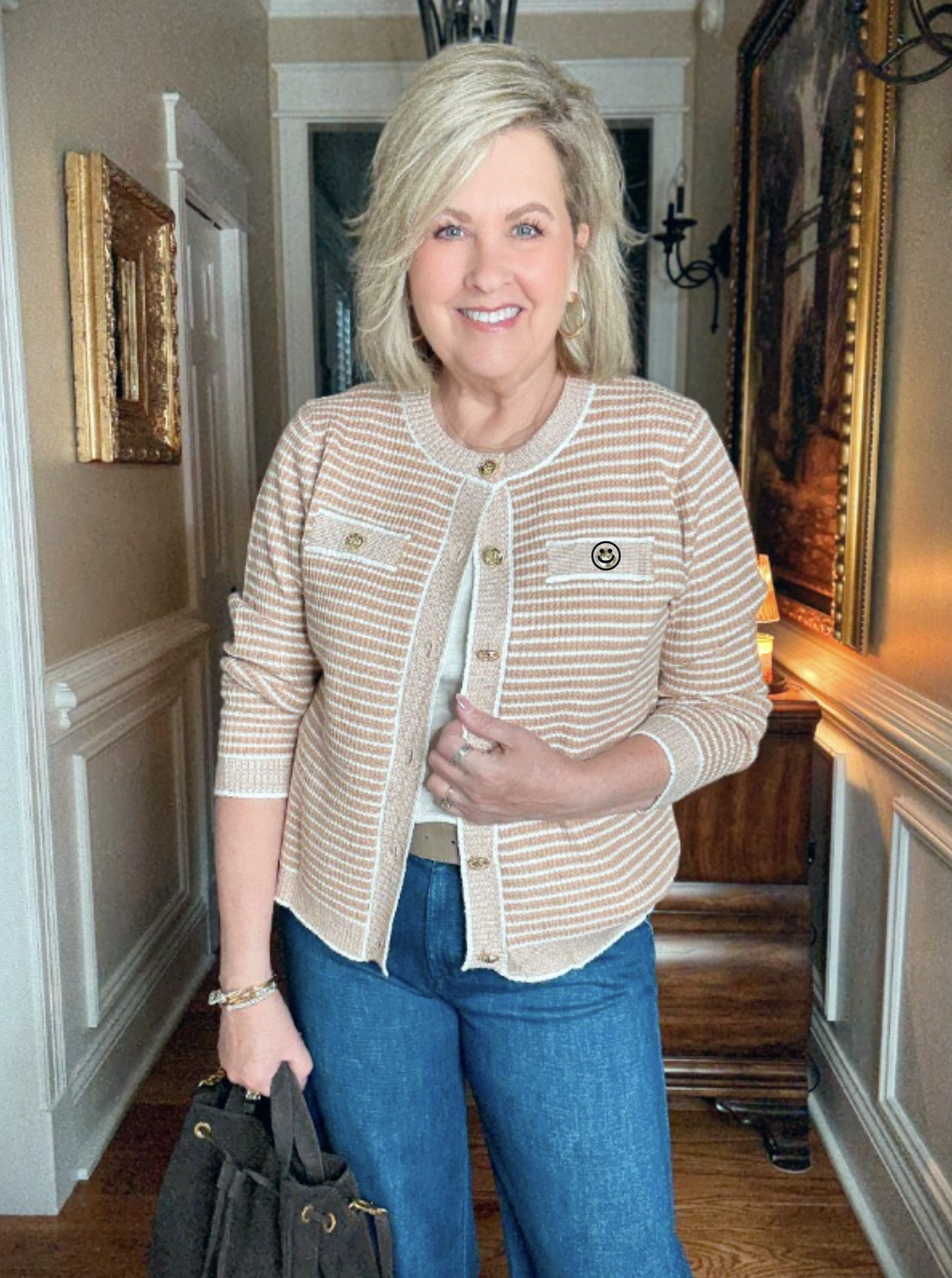 Tania is wearing a camel plaid jacket with a white tee