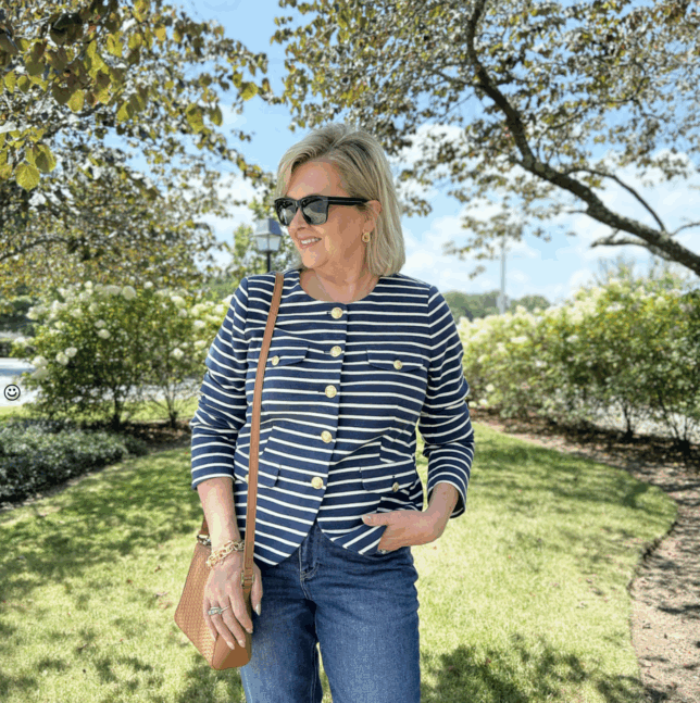 Tania wearing a striped knit jacket with trees in the background