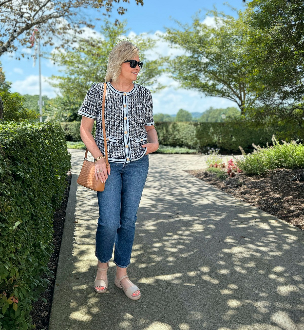 Tania wearing jeans and a short sleeve knit cardigan from Talbots on a sidewalk