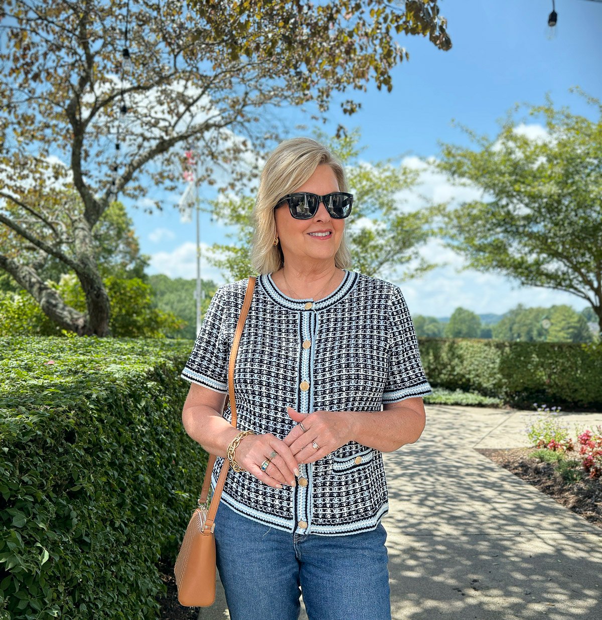 Tania wearing a short sleeve knit cardigan from Talbots on a sidewalk