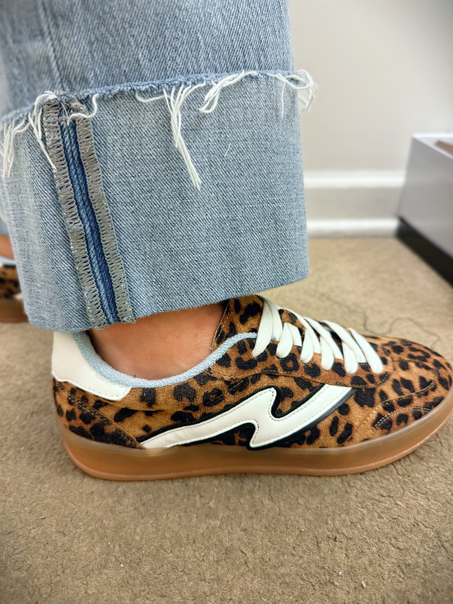 Stephanie wearing Belk-Cheetah-Sneakers and wide cuff frayed jeans