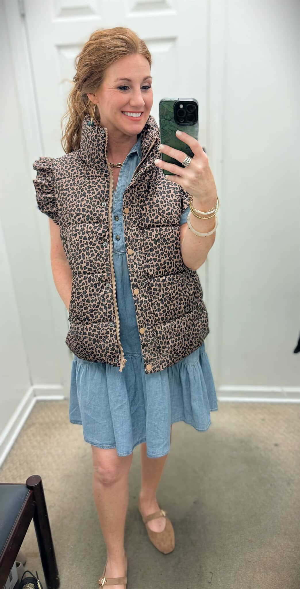 Stephanie wearing a Belk-cheetah-puffer-vest-denim-dress-and-flats