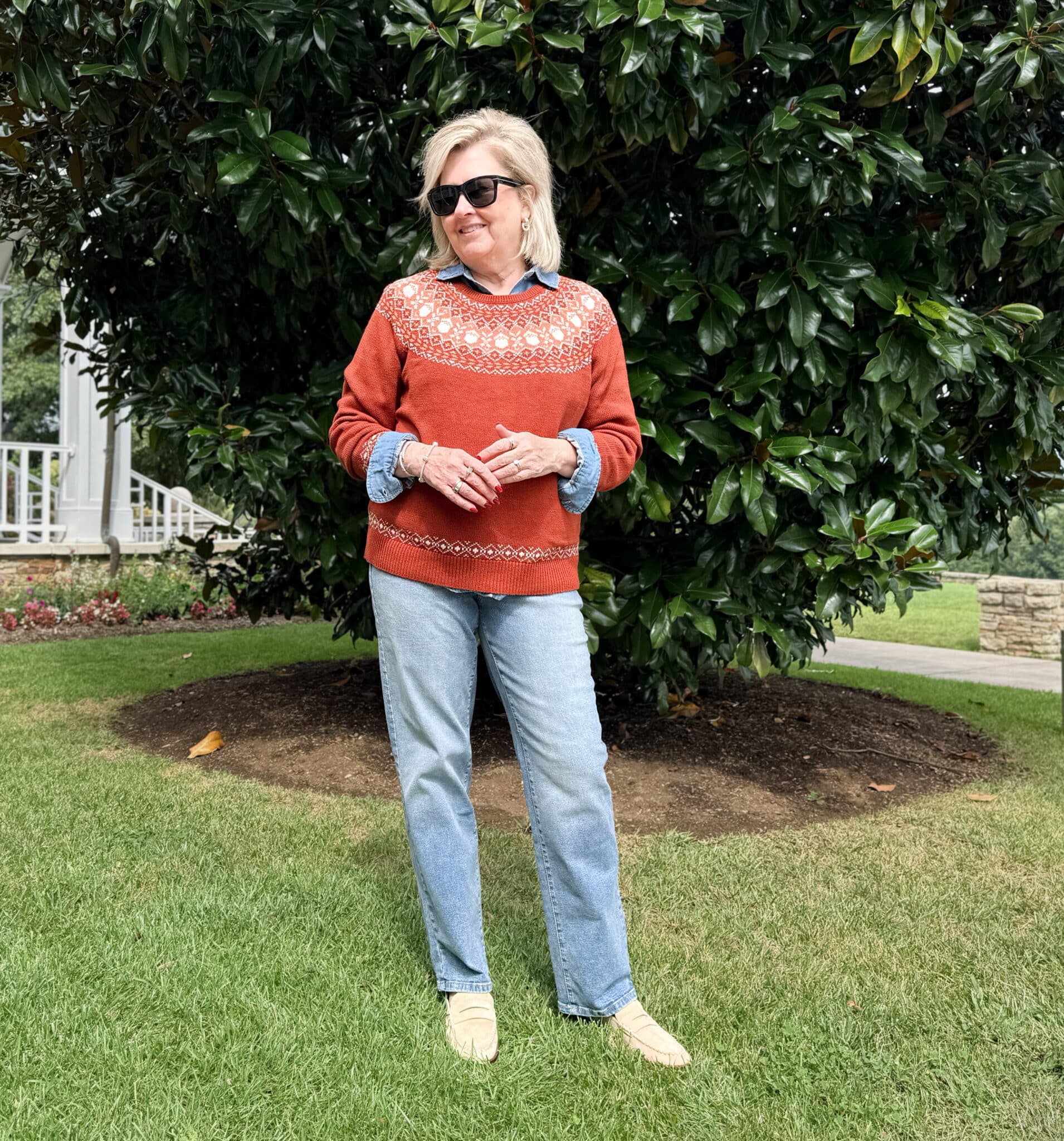 Tania wearing a rust FairIsle sweater with a chambray shirt and straight leg jeans from Kohl's