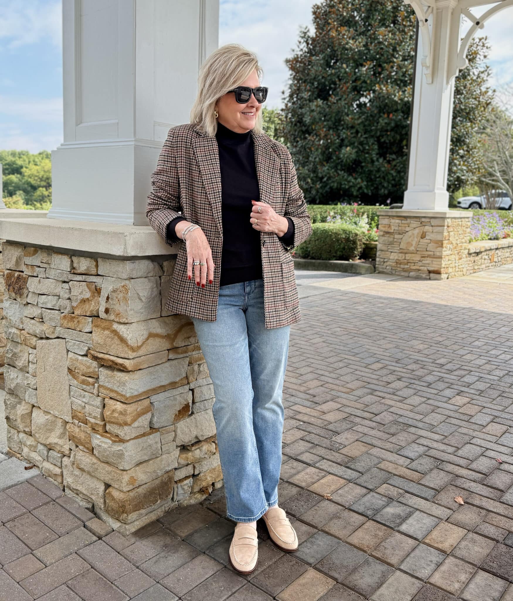 Tania wearing a plaid blazer with a black turtleneck and straight leg jeans from Kohl's