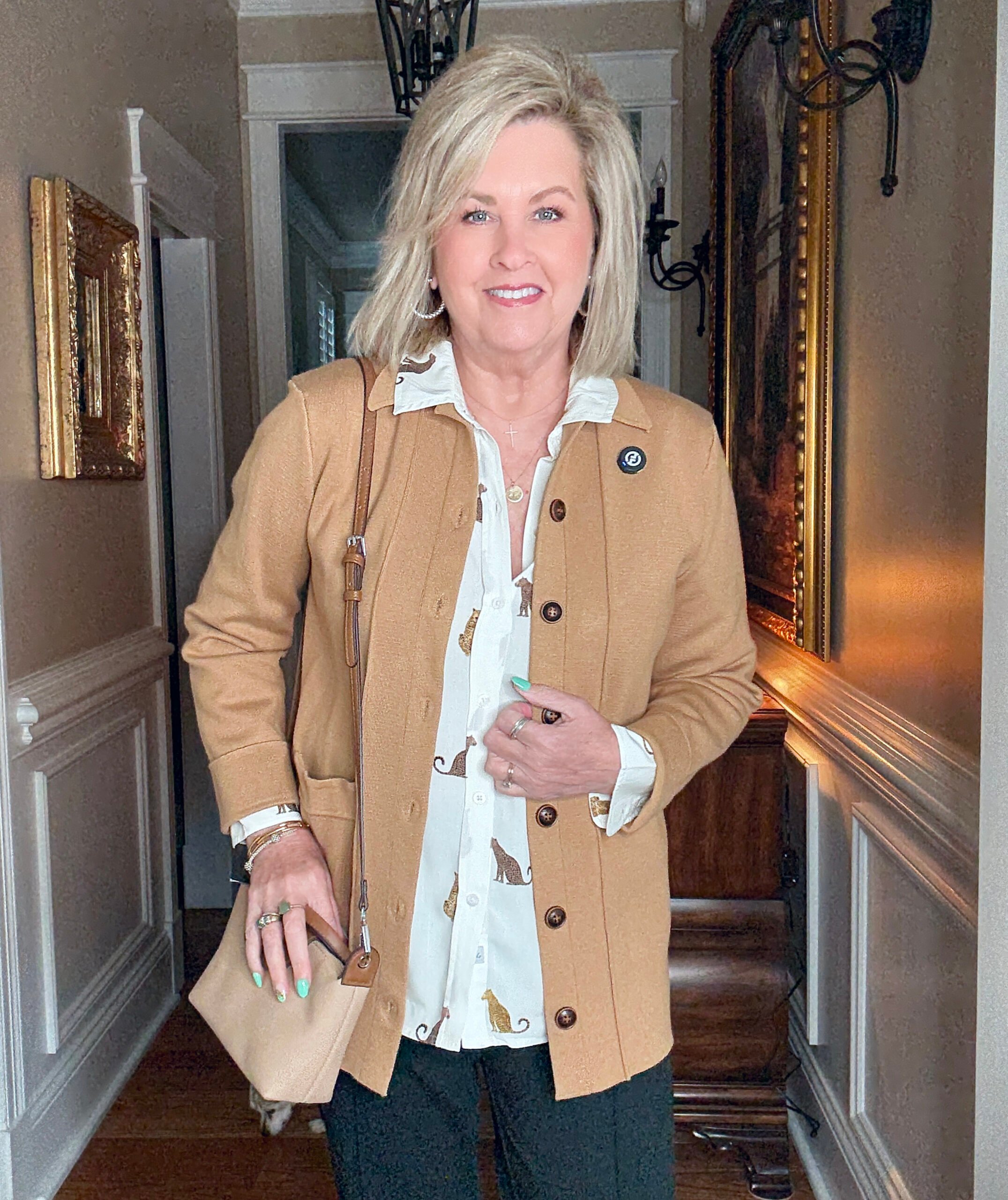 Tania wearing a cheetah button up shirt with a knit blazer