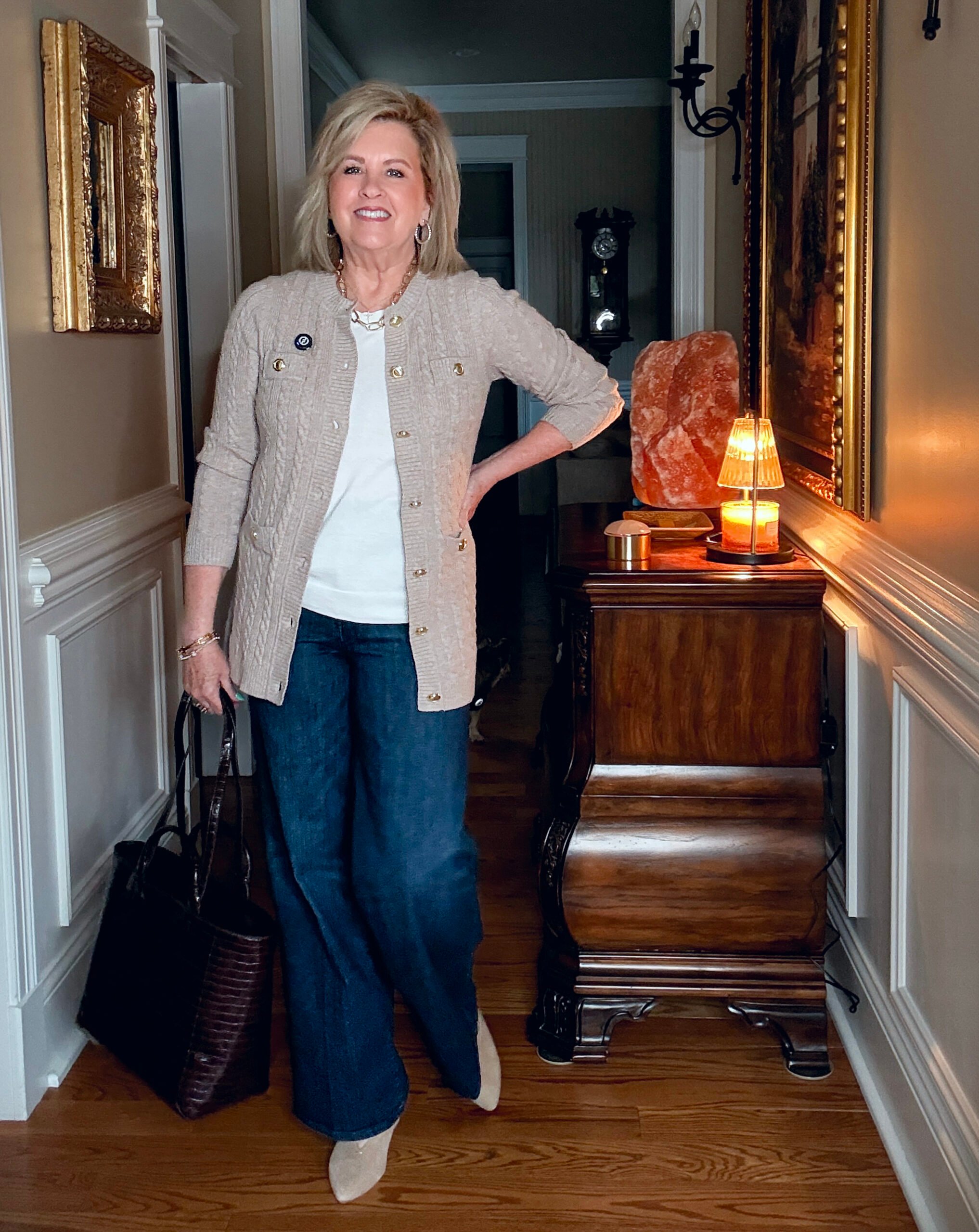 Tania wearing a cable knit sweater from Ann Taylor with dark wash jeans