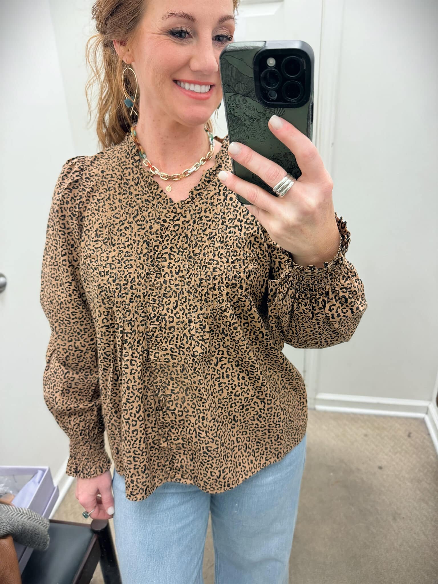 Stephanie wearing a Belk-frayed-cuff-jeans-and a cheetah-top