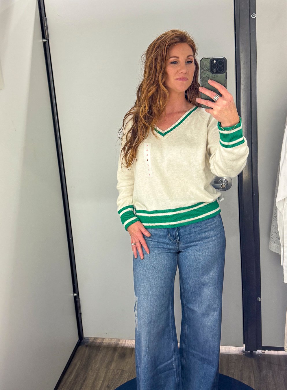 Stephanie wearing a white sweater with green trim and wide leg jeans for fall from Old Navy