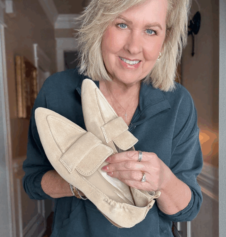 Tania holding a pair of suede loafers for fall