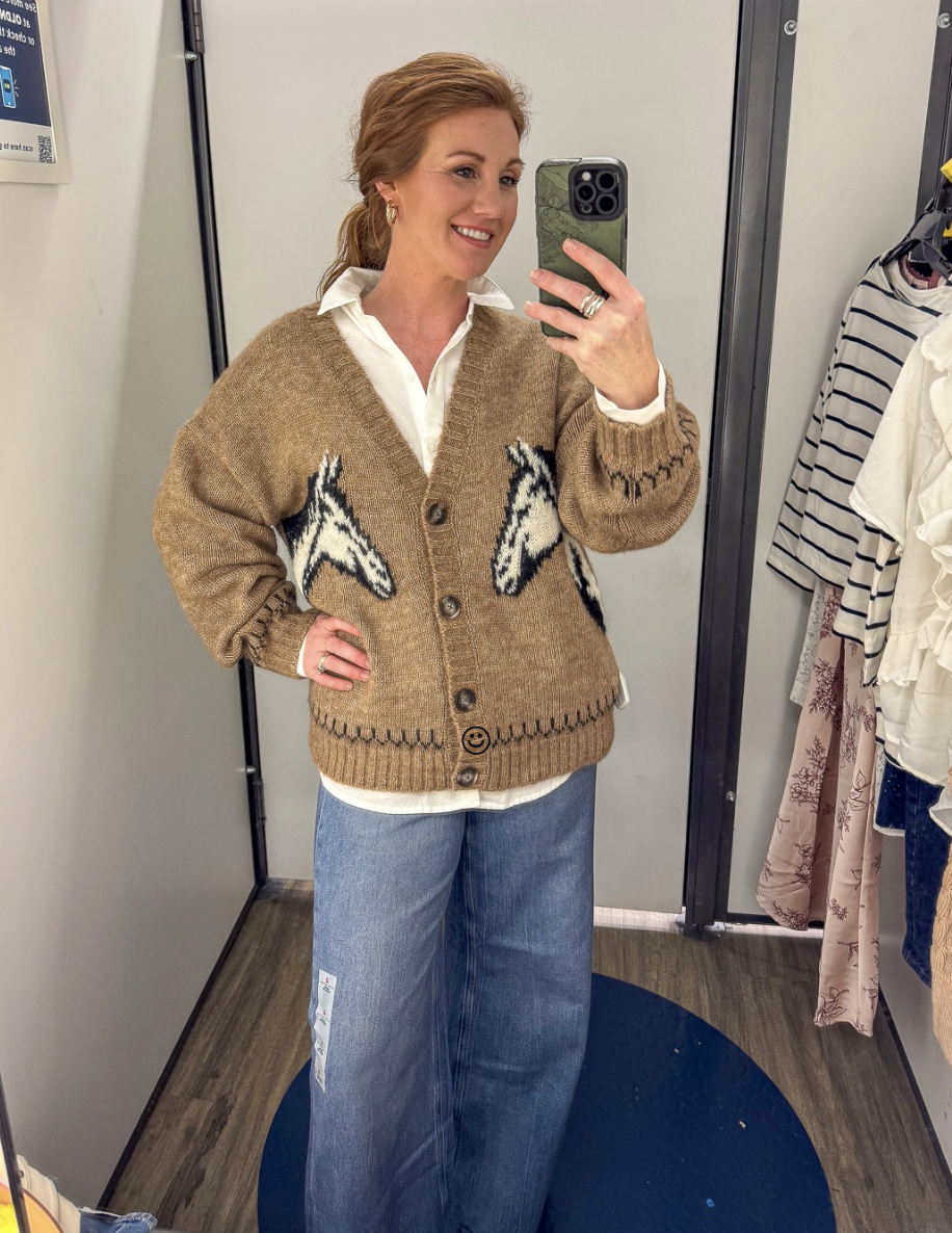 Stephanie wearing a brown horse sweater with a white boyfriend shirt and wide leg jeans for fall from Old Navy