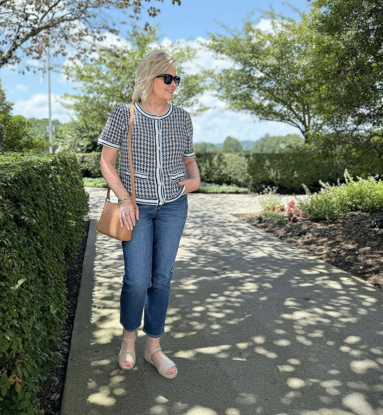 Tania wearing jeans and a short sleeve knit cardigan from Talbots on a sidewalk
