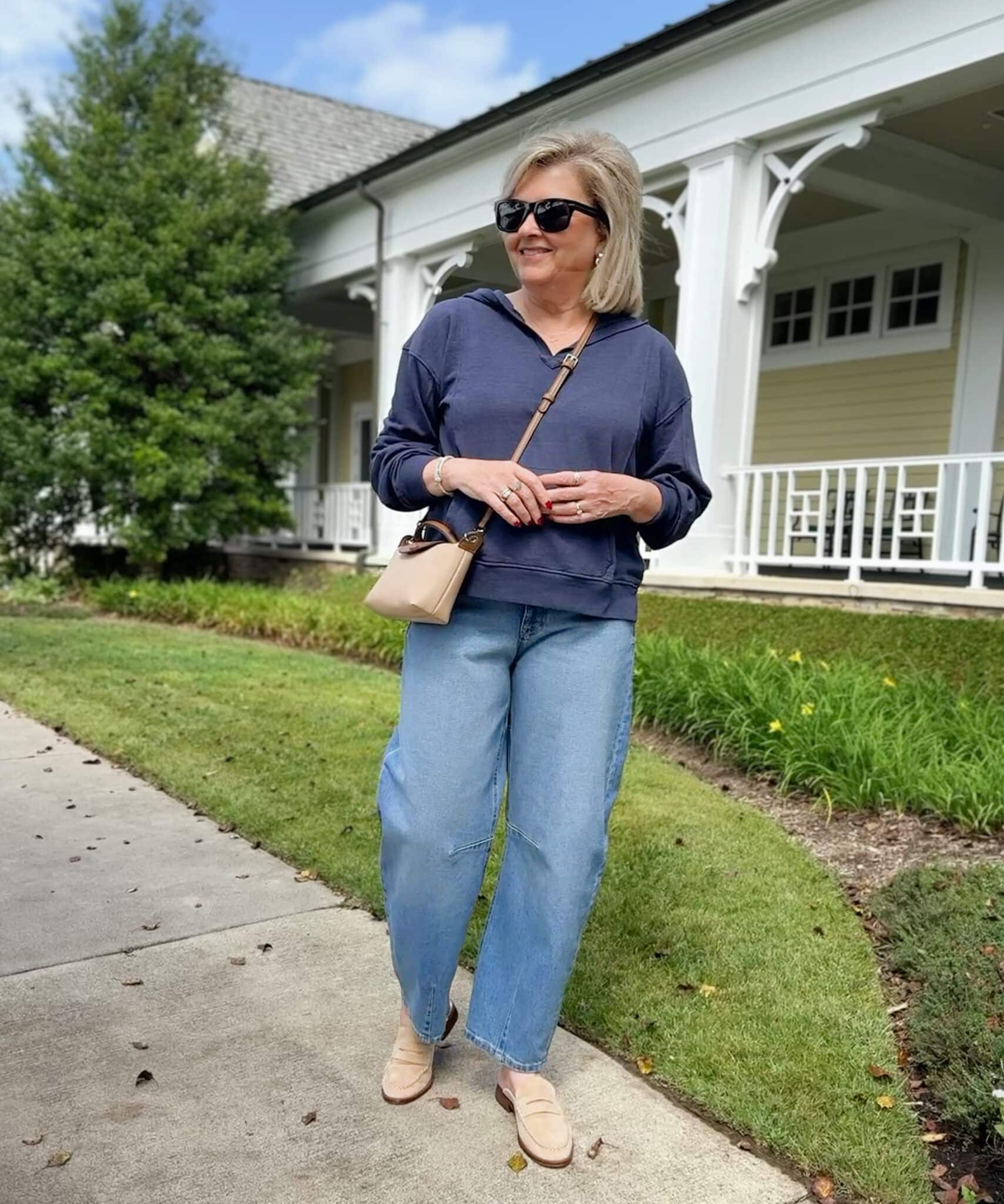 Tania Stephens wearing a Walmart blue hoodie with barrel leg jeans