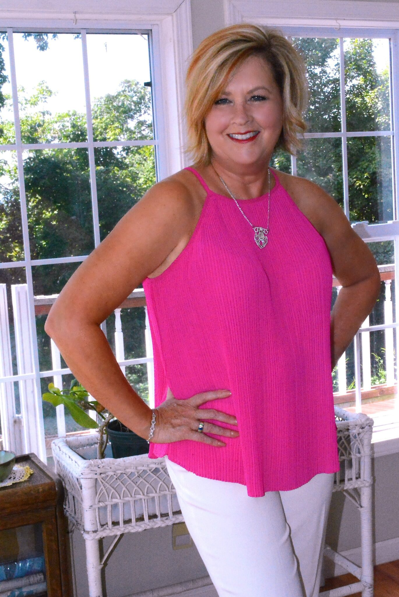 Tania wearing a bright pink top with JTV jewelry