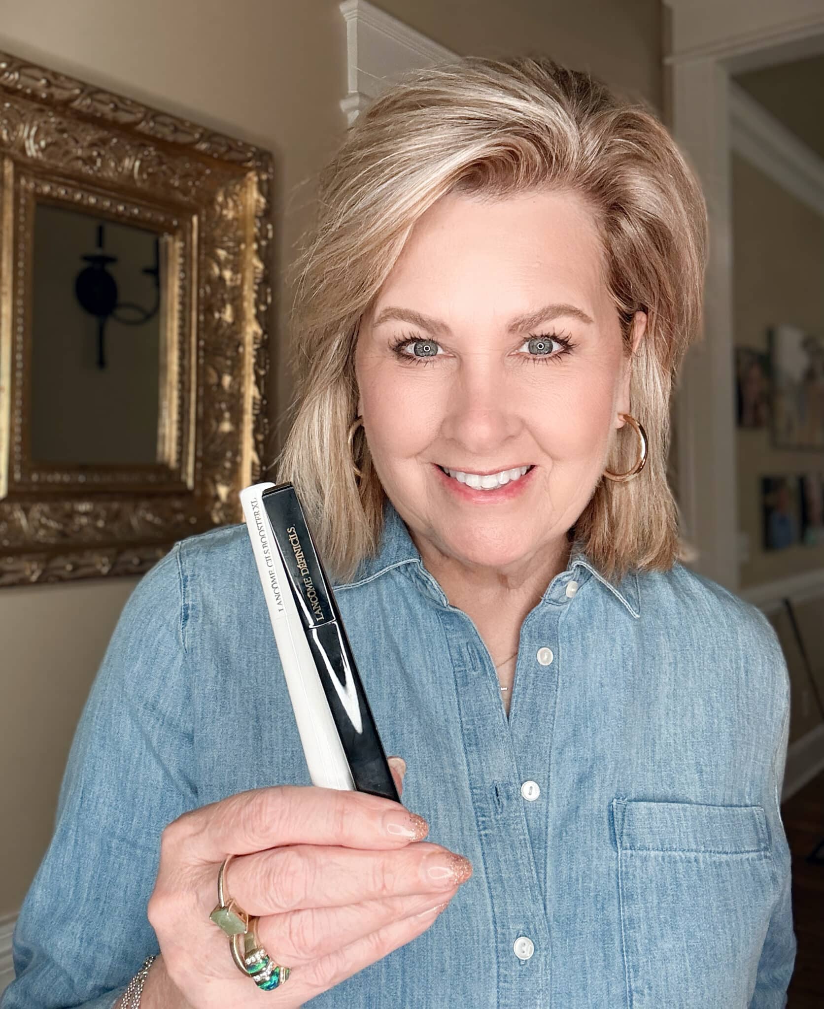 Woman holding Lancôme Défincils Mascara and Cils Booster XL Primer set from Nordstrom Beauty.