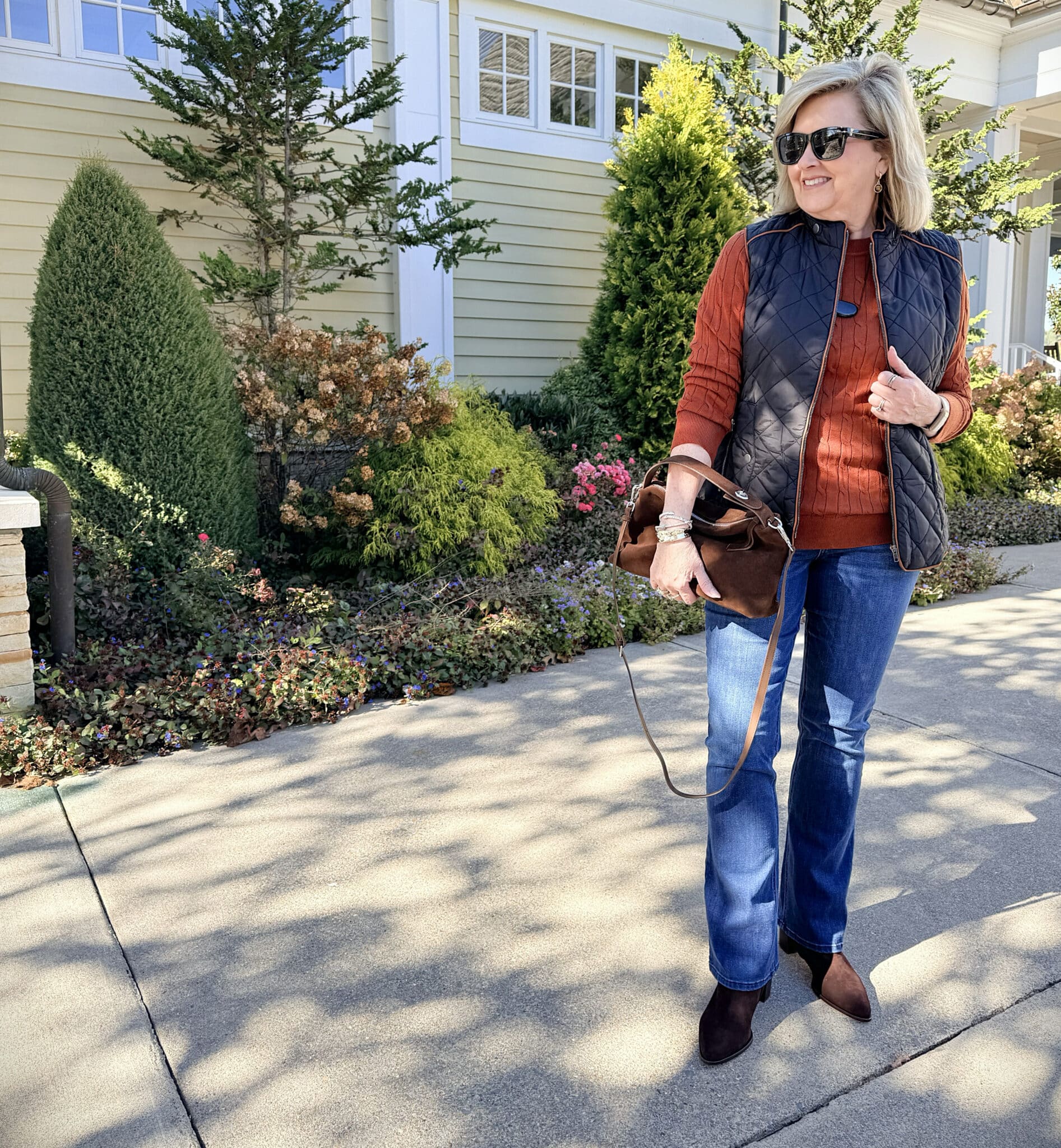 Tania wearing an Amazon black quilted vest with jeans