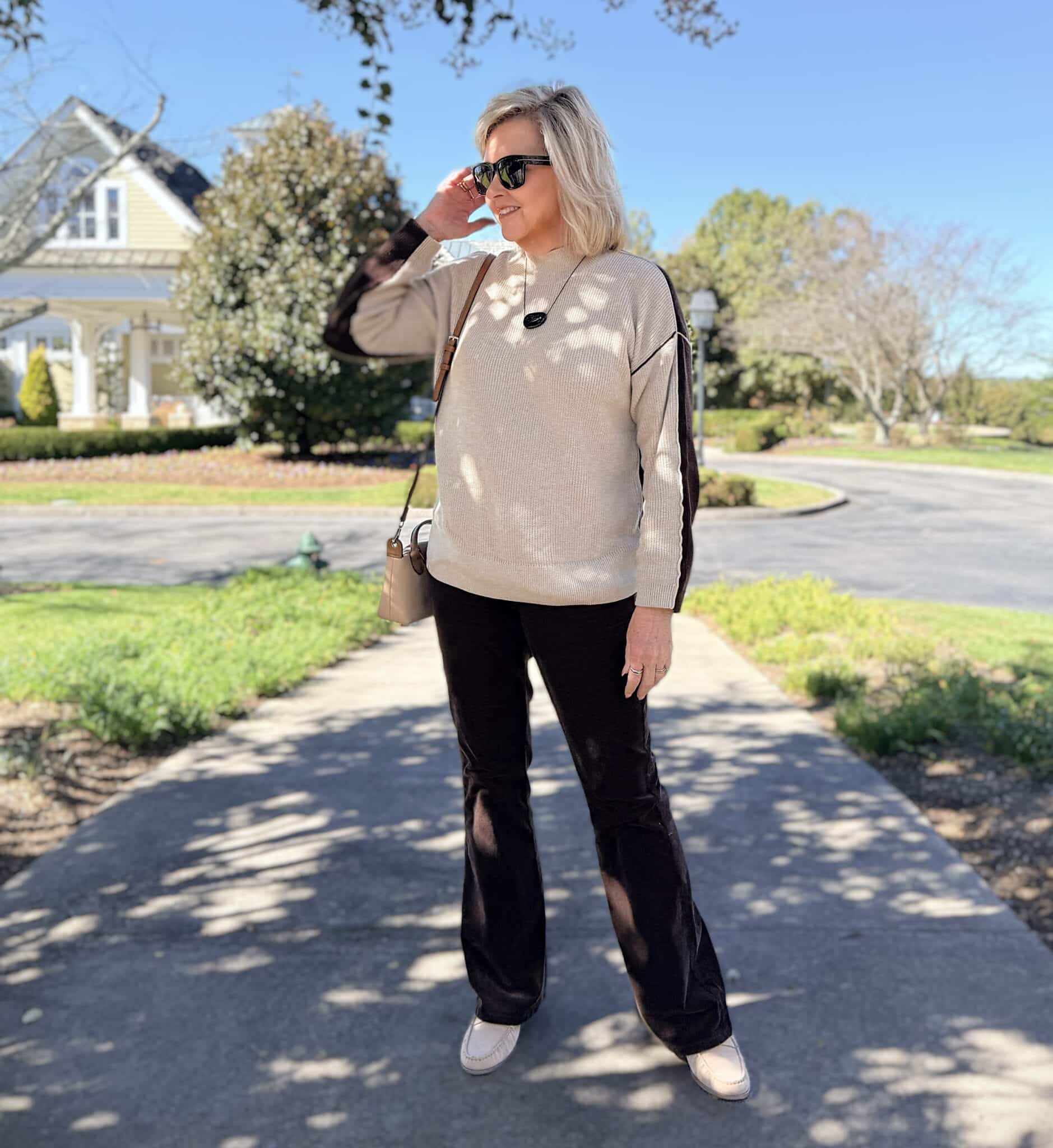 Tania wearing a color block sweater with corduroy pants