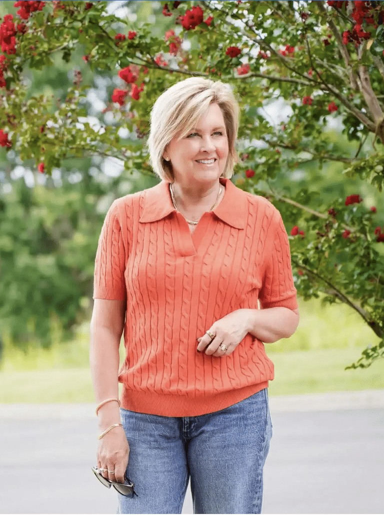 An Amazon short sleeve cableknit polo sweater paired with jeans on a woman