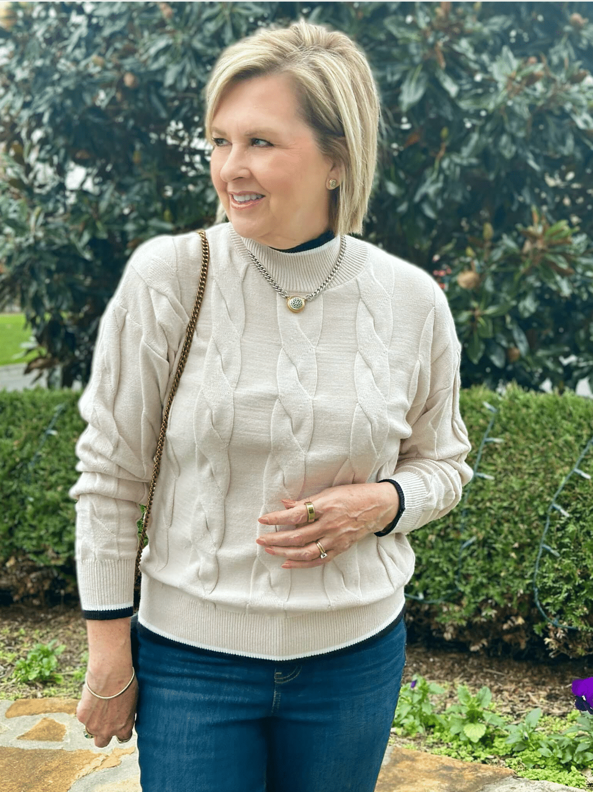 Tania Stephens is wearing an ivory Amazon cable knit sweater with black trim