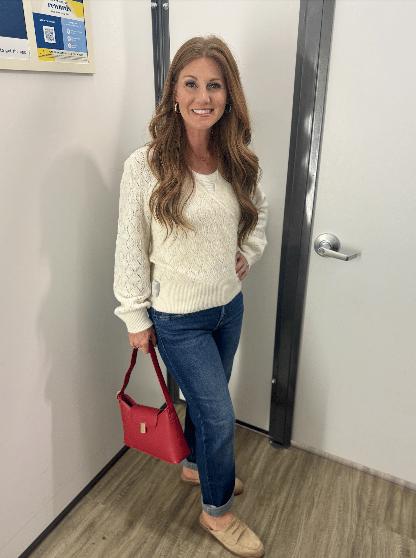 Stephanie in a Pointelle sweater with a boyfriend jeans and a red handbag from Old Navy