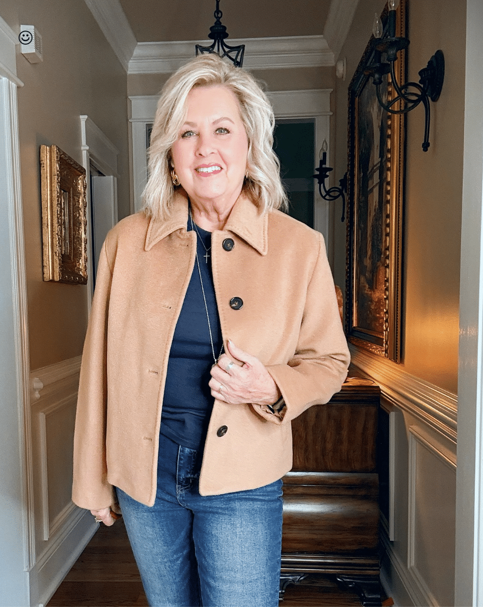 Tania wearing a navy tee with a camel short jacket from Quince