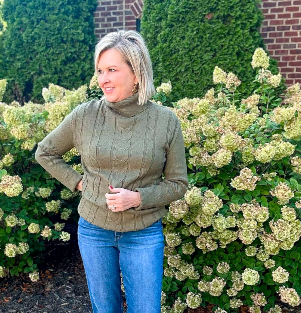 A green turtleneck sweater styled for fall and winter