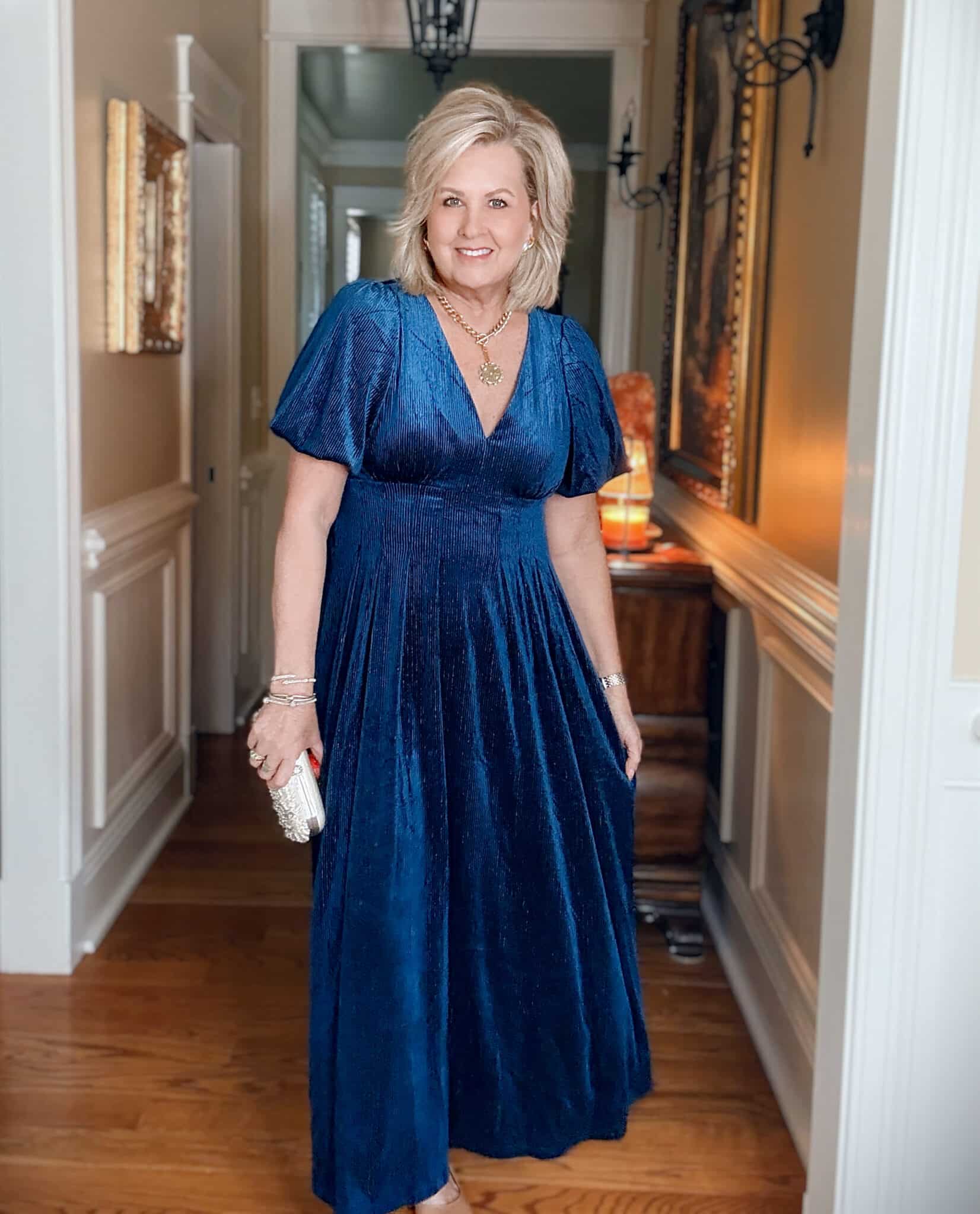 Tania wearing an Amazon blue velvet dress with a metallic stripe