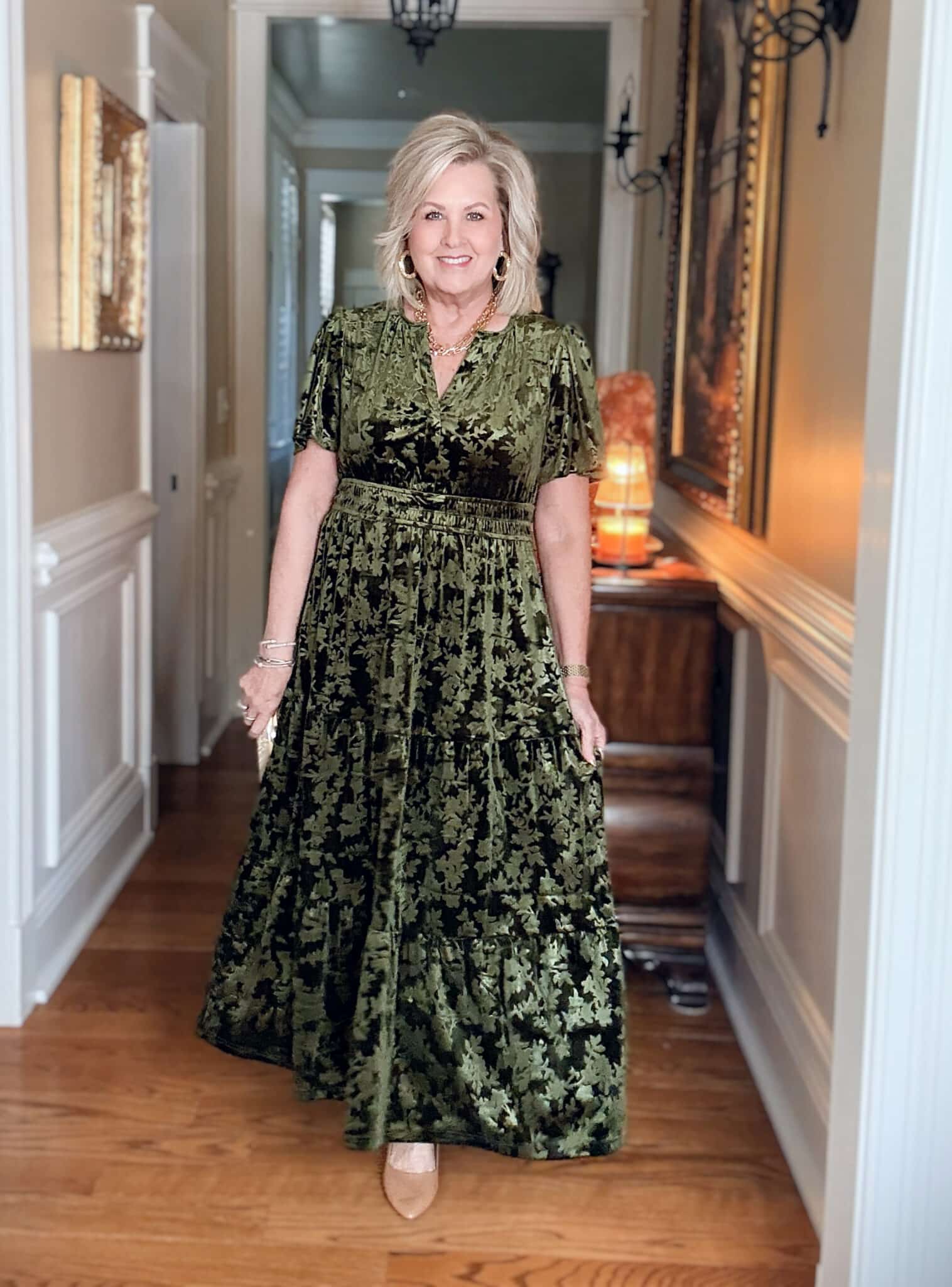 Tania wearing an Amazon green velvet dress with neutral heels