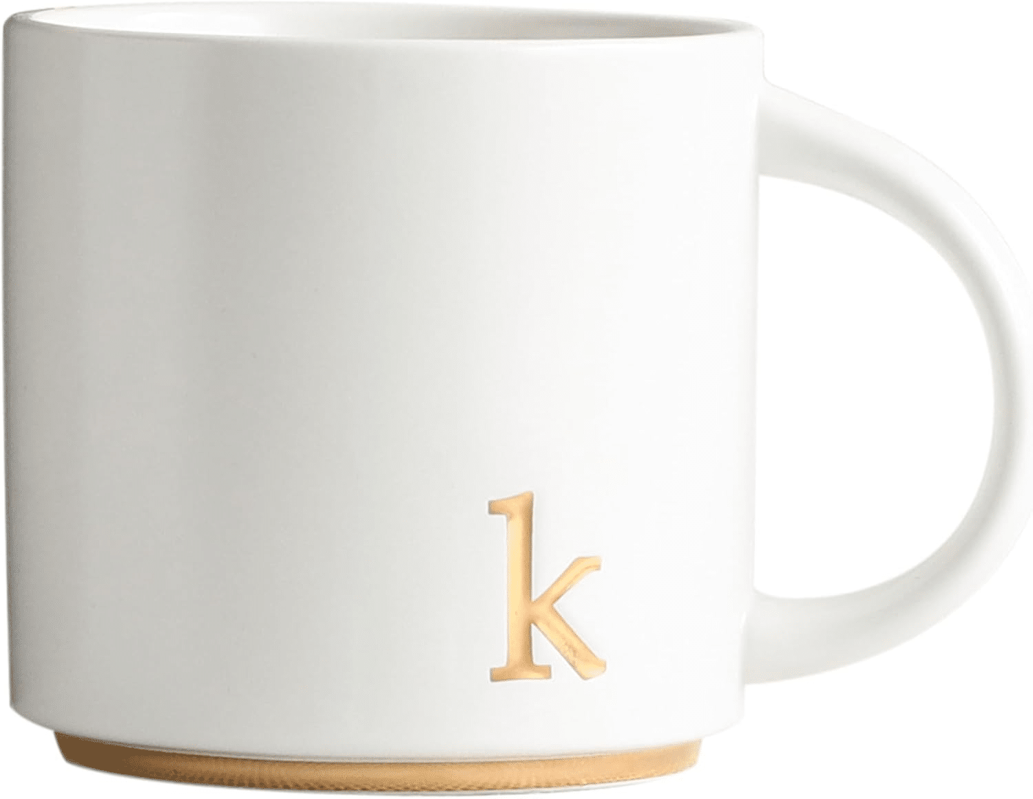 White ceramic monogram mug with gold detailing filled with tea, perfect for a cozy night at home.