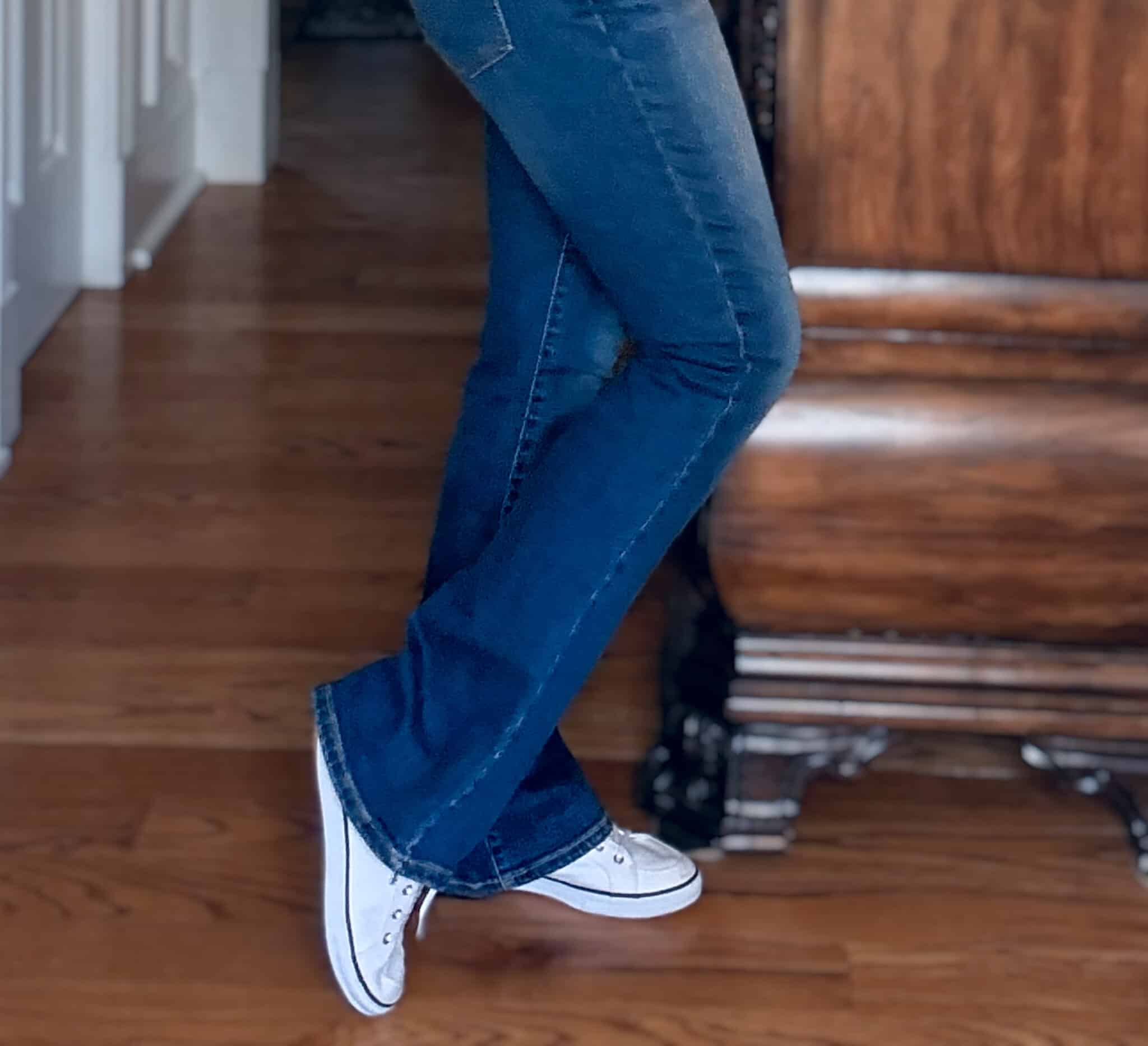 Tania wearing dark wash flare jeans with Keds sneakers
