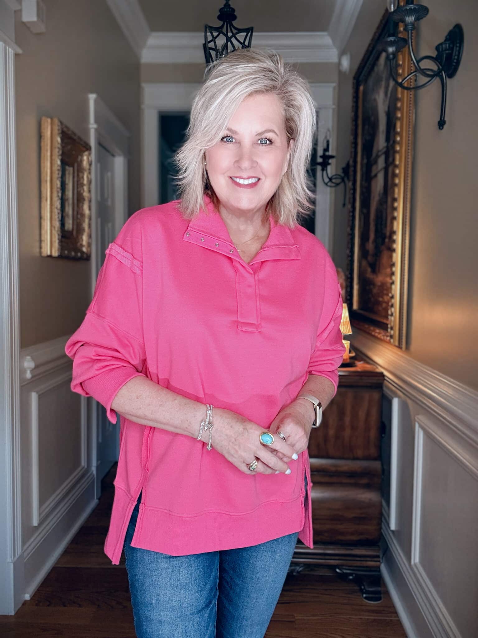 Tania wearing a bright pink oversized sweatshirt from Amazon