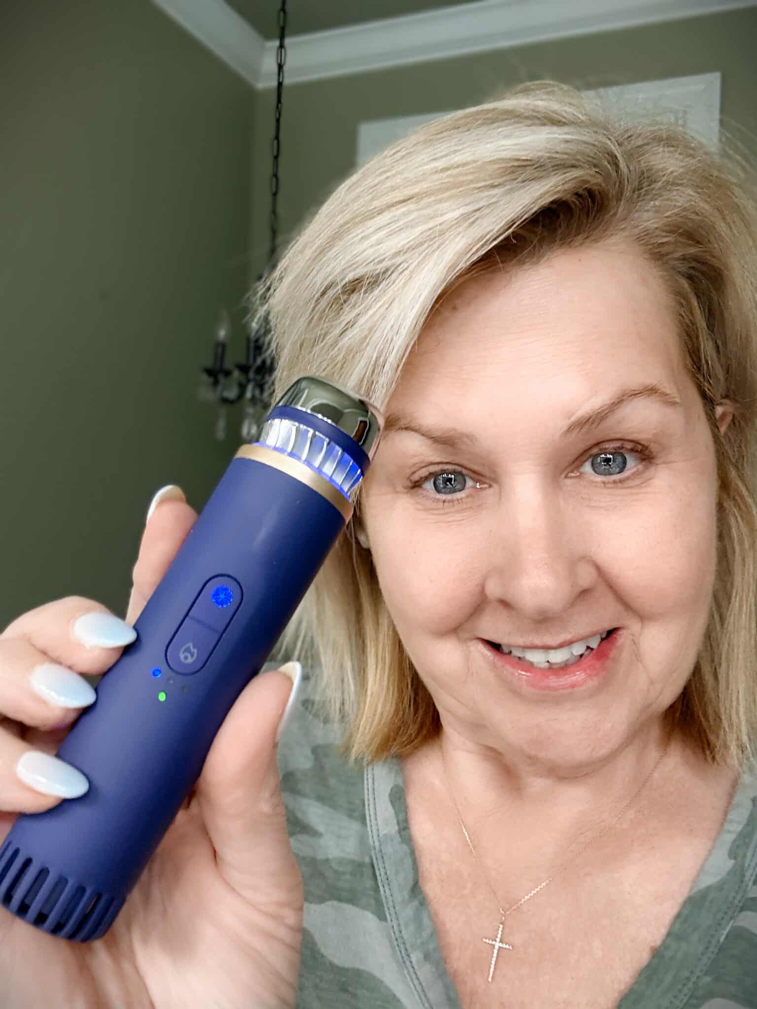 Tania holding the Therabody TheraFace Depuffing Wand