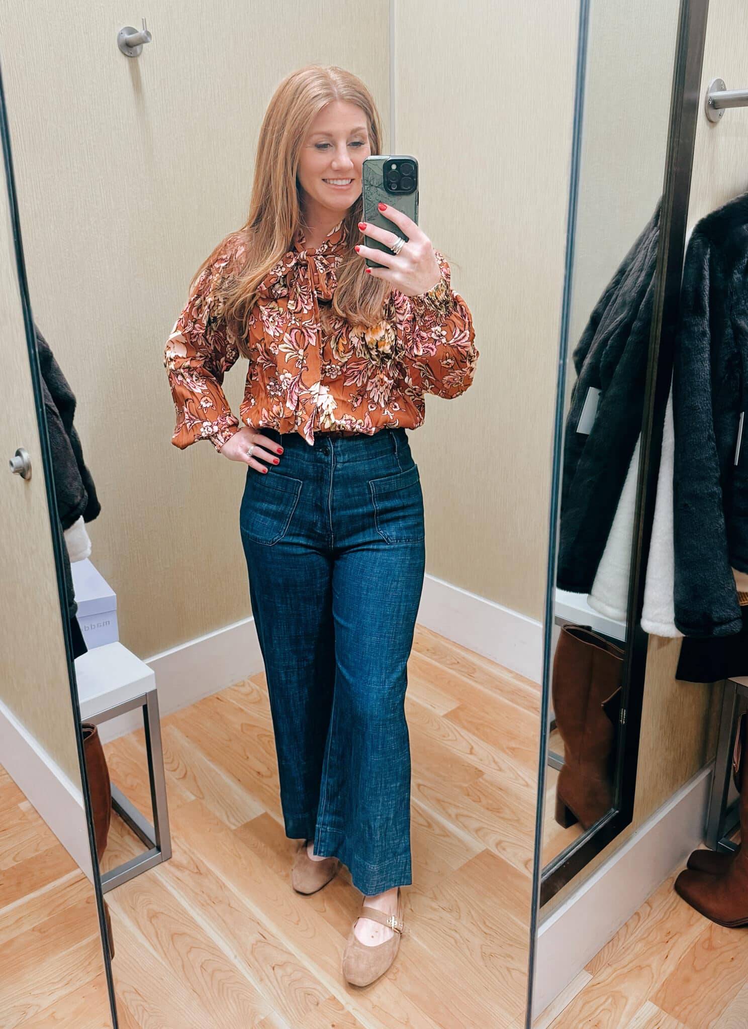 Stephanie wearing a tucked in shirt with jeans