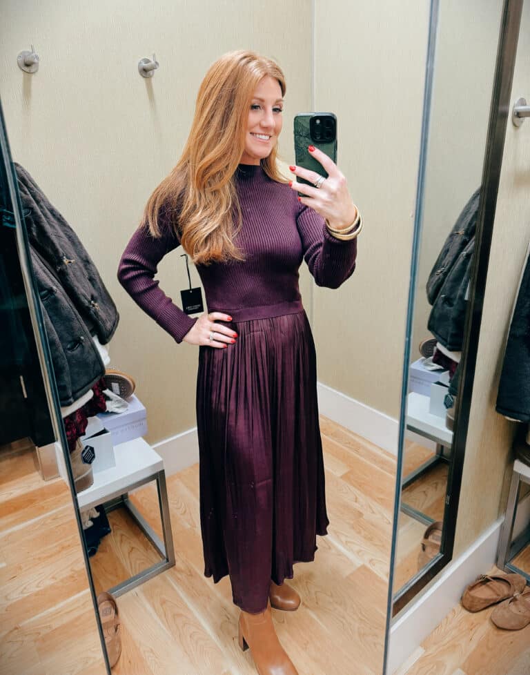 Stephanie wearing a wine colored dress with boots