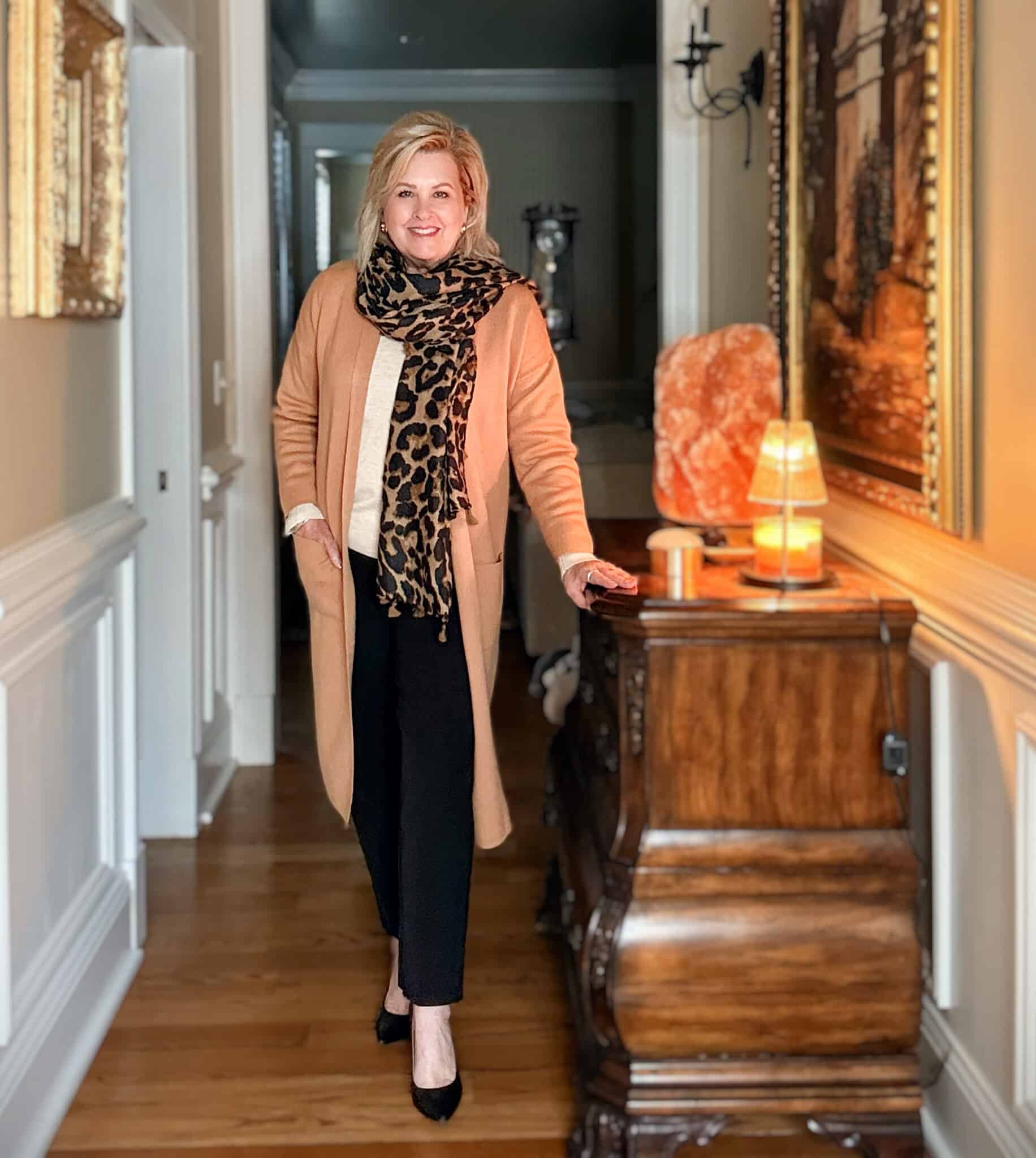 Tania wearing black pants with a long duster cardigan and leopard print scarf from Amazon
