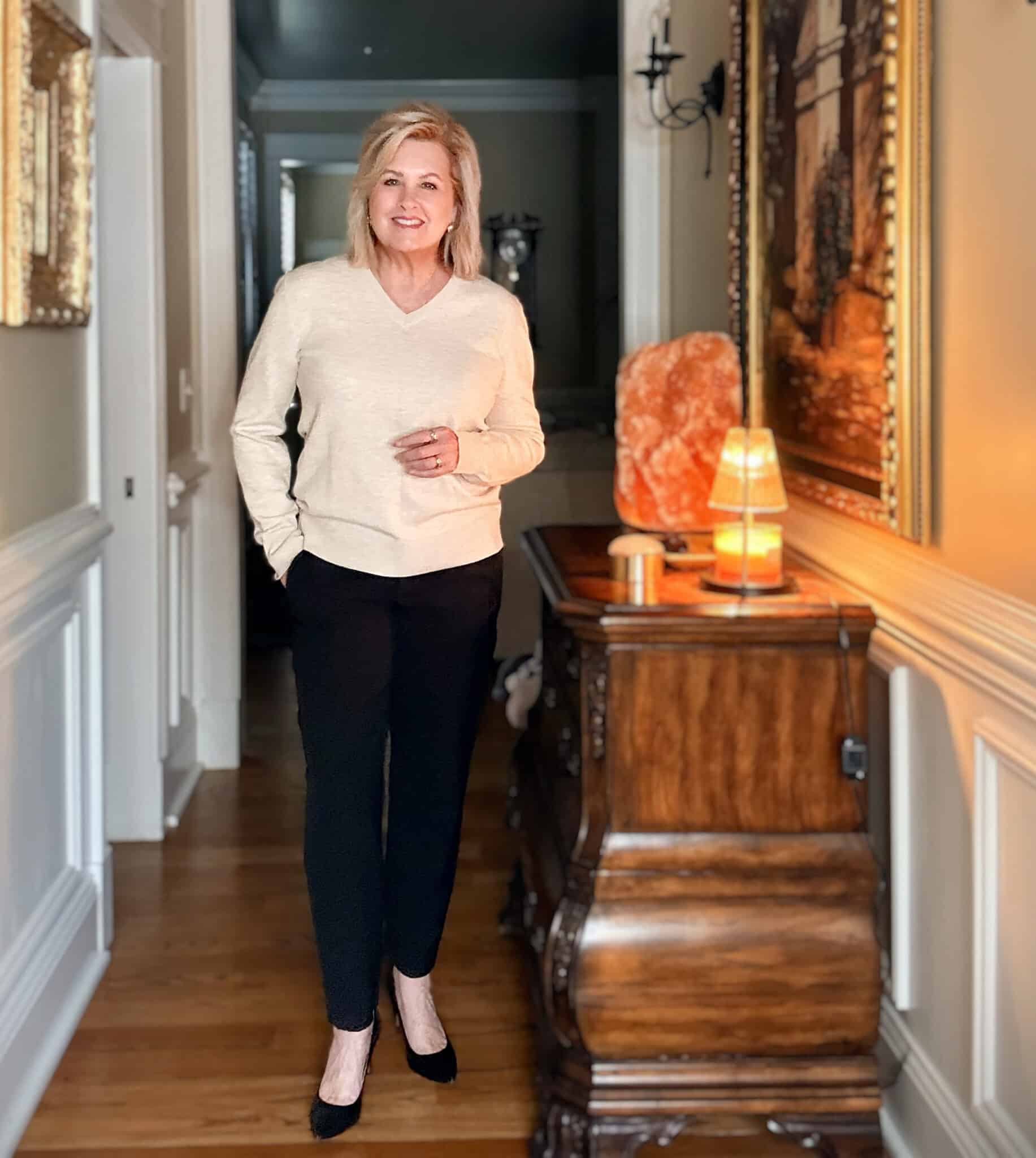 Tania wearing black pants with a cream sweater from Amazon