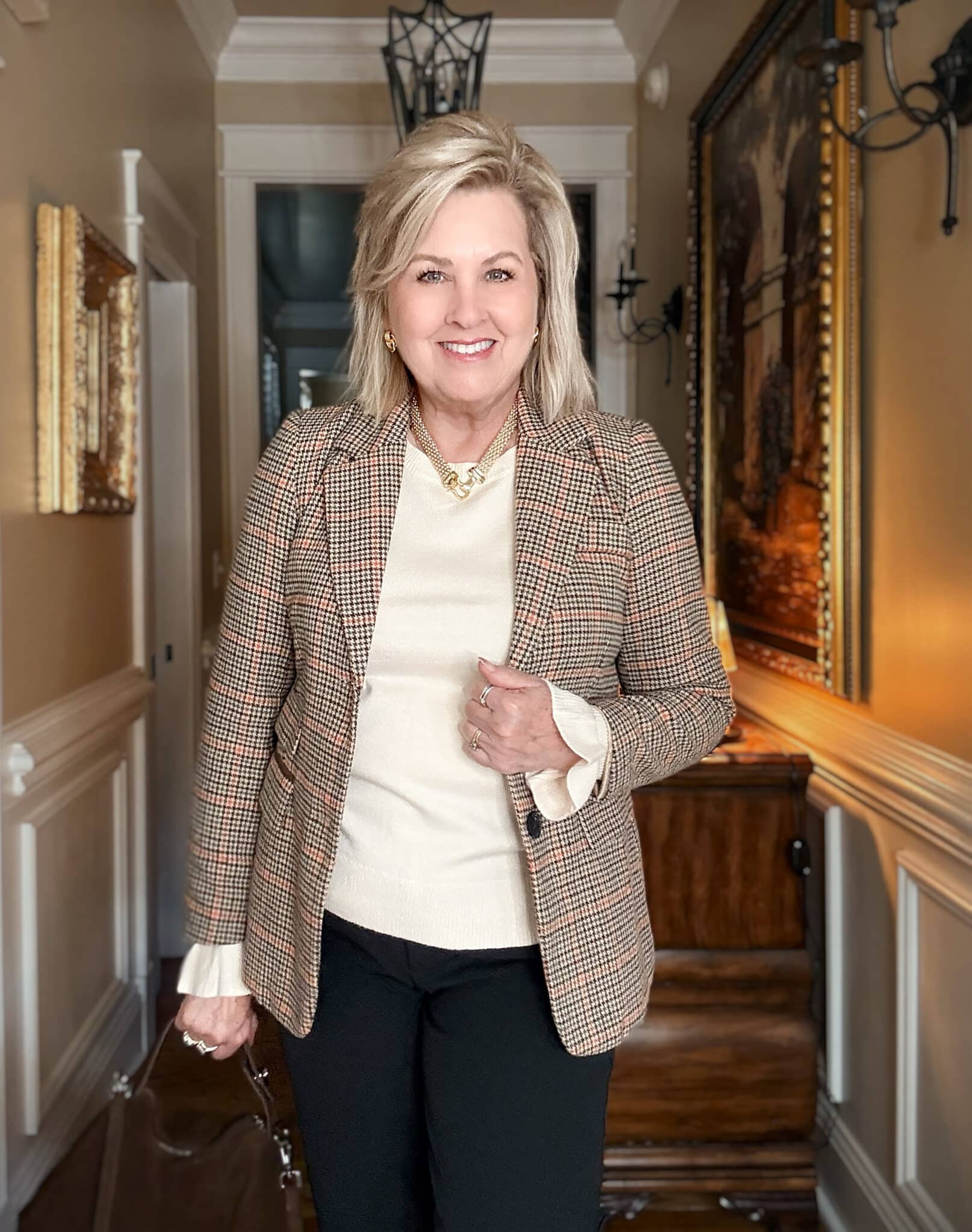 Tania wearing black pants with a plaid blazer with a ruffled sleeve sweater from Amazon